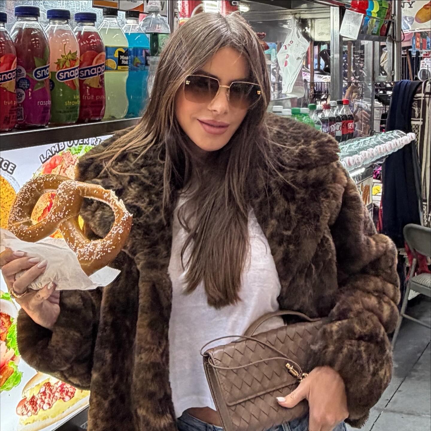 Sofía Vergara keeps cozy in a Sofia jacket while snacking on a pretzel.