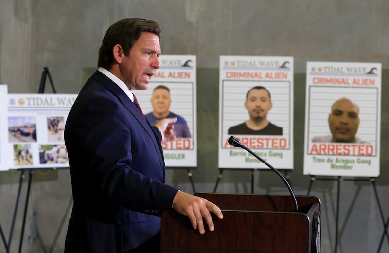 MIRAMAR, FLORIDA - MAY 01: Florida Gov. Ron DeSantis speaks during a press conference, in front of posters of people that law enforcement arrested, held at the ICE-Enforcement and Removal Operation office on May 01, 2025 in Miramar, Florida. DeSantis talked about a multi-agency immigration enforcement effort named Operation Tidal Wave that they say resulted in more than 1,100 arrests in a single week in Florida. (Photo by Joe Raedle/Getty Images)