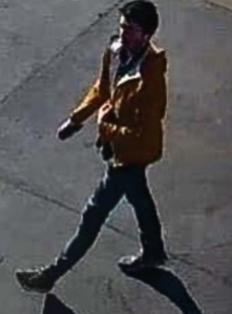 CCTV image of Tyler Pavlick walking while talking on the phone.