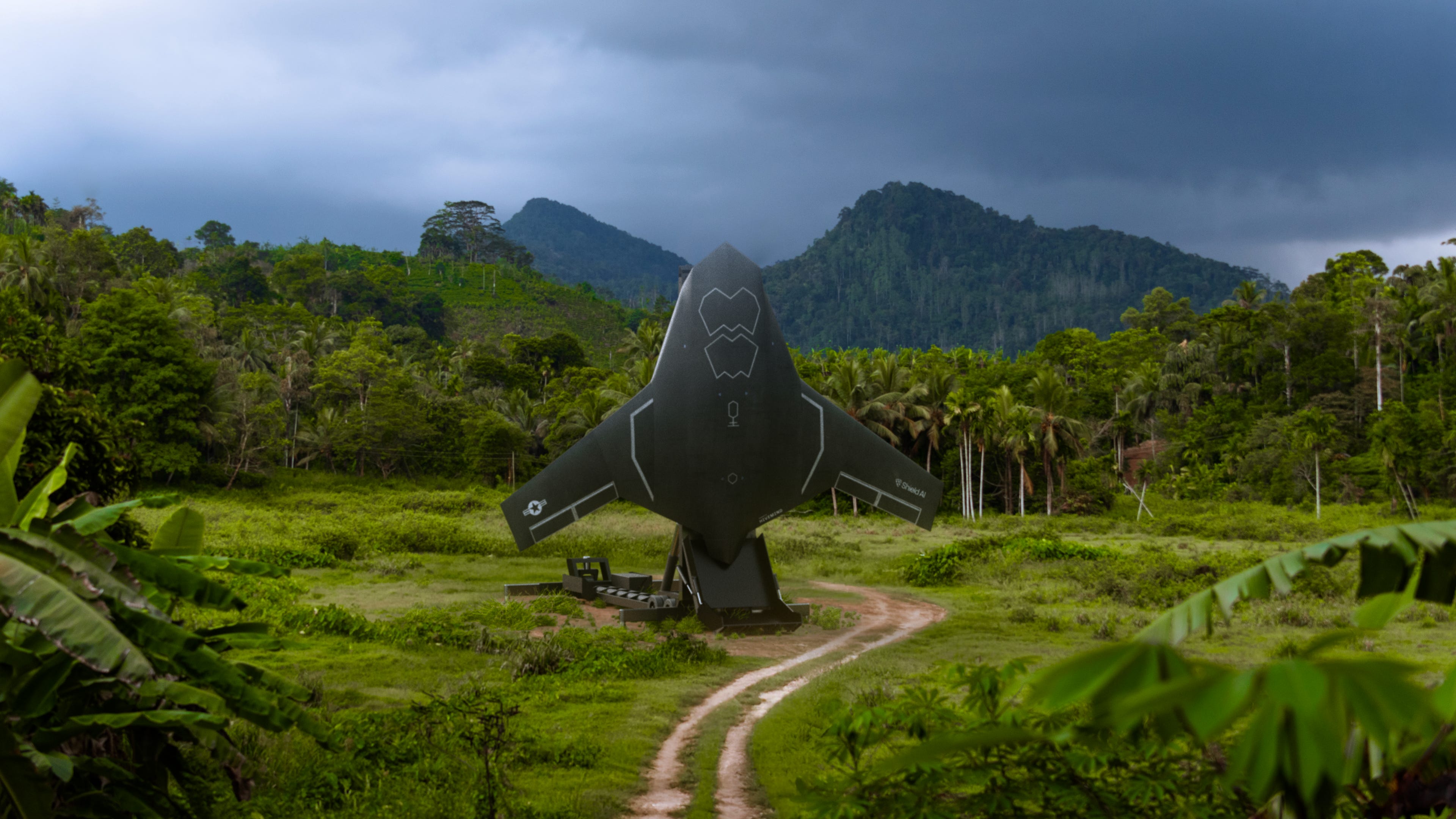 A black winged jet standing up in the middle of a jungle clearing with a mountain in the background