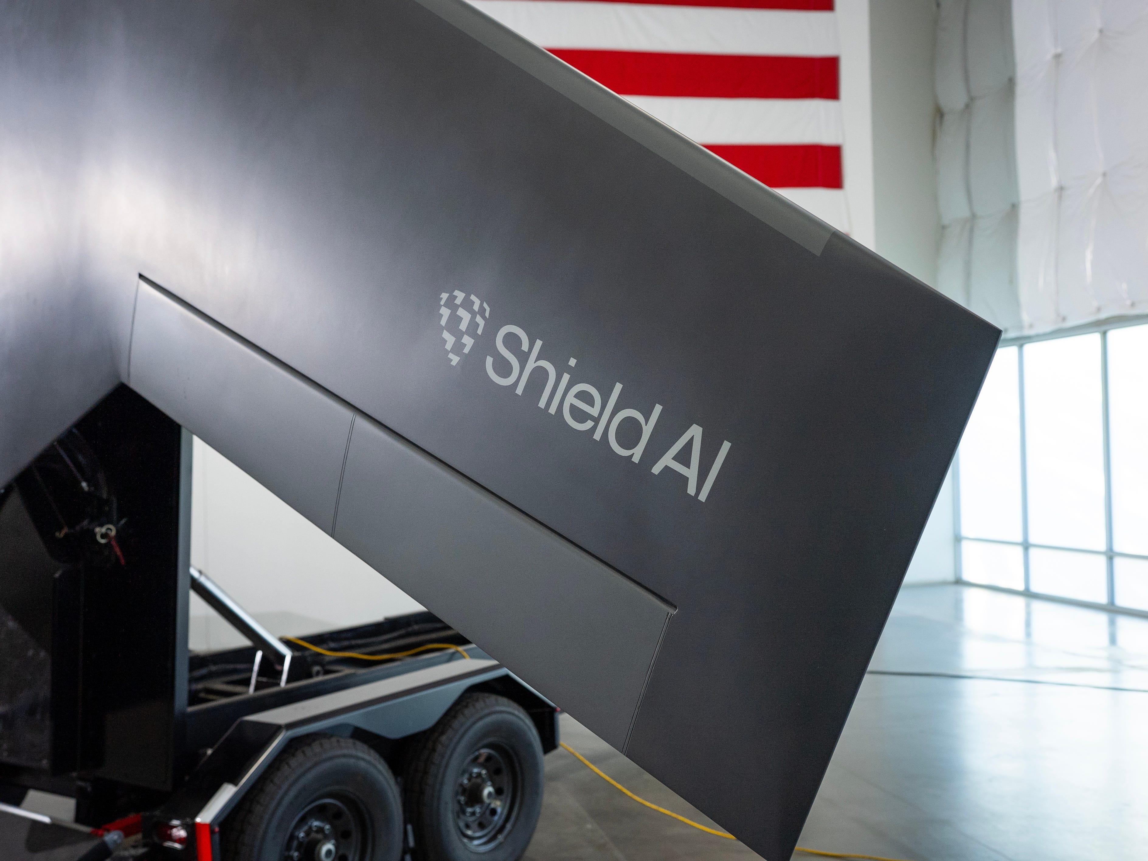 A black wing with the Shield AI logo on it