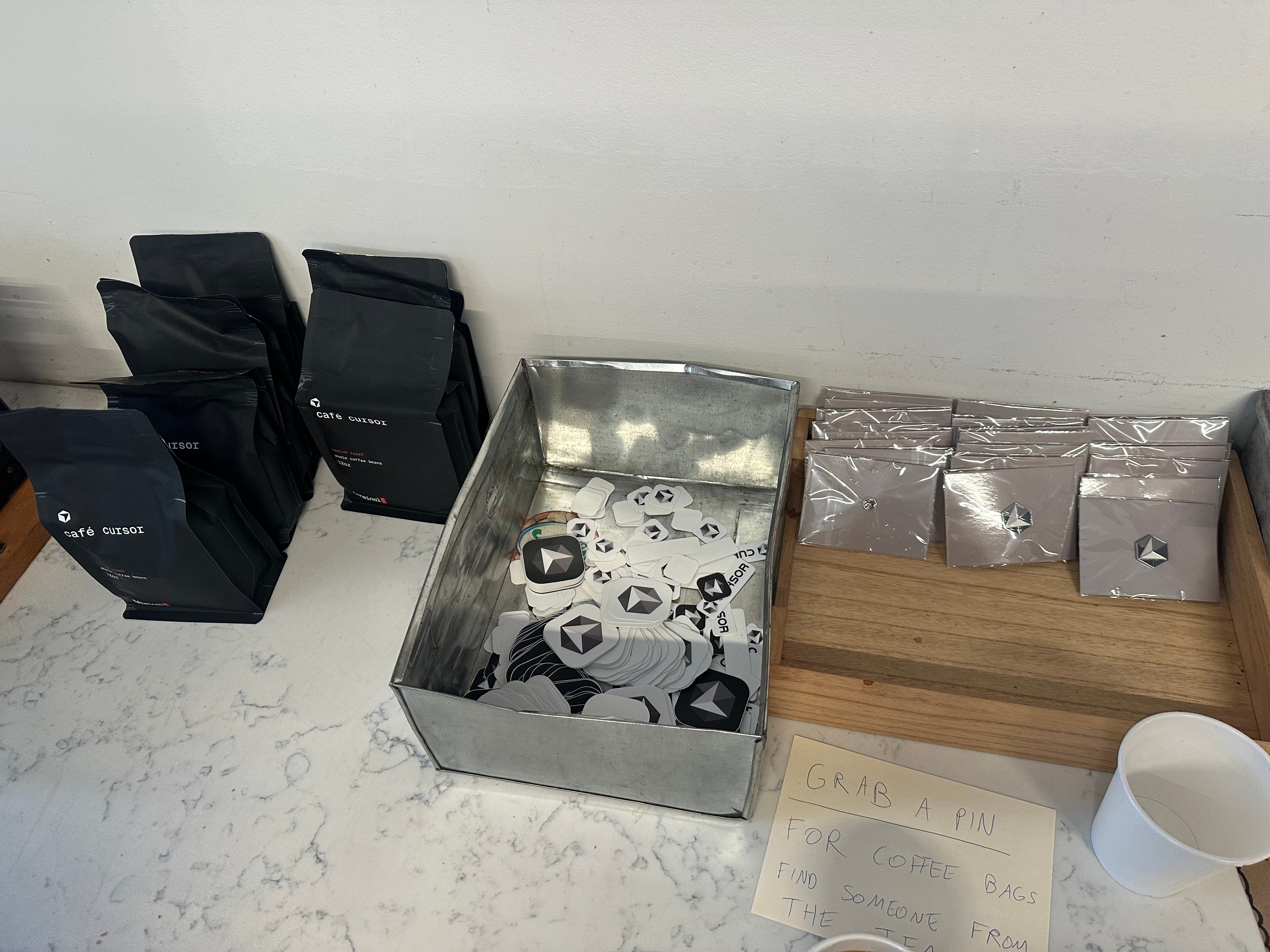 Cursor's stickers and pins are pictured.