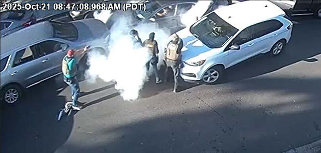 Federal agents aim their guns at a driver during a shooting in Los Angeles, Calif., on Oct. 21, 2025.