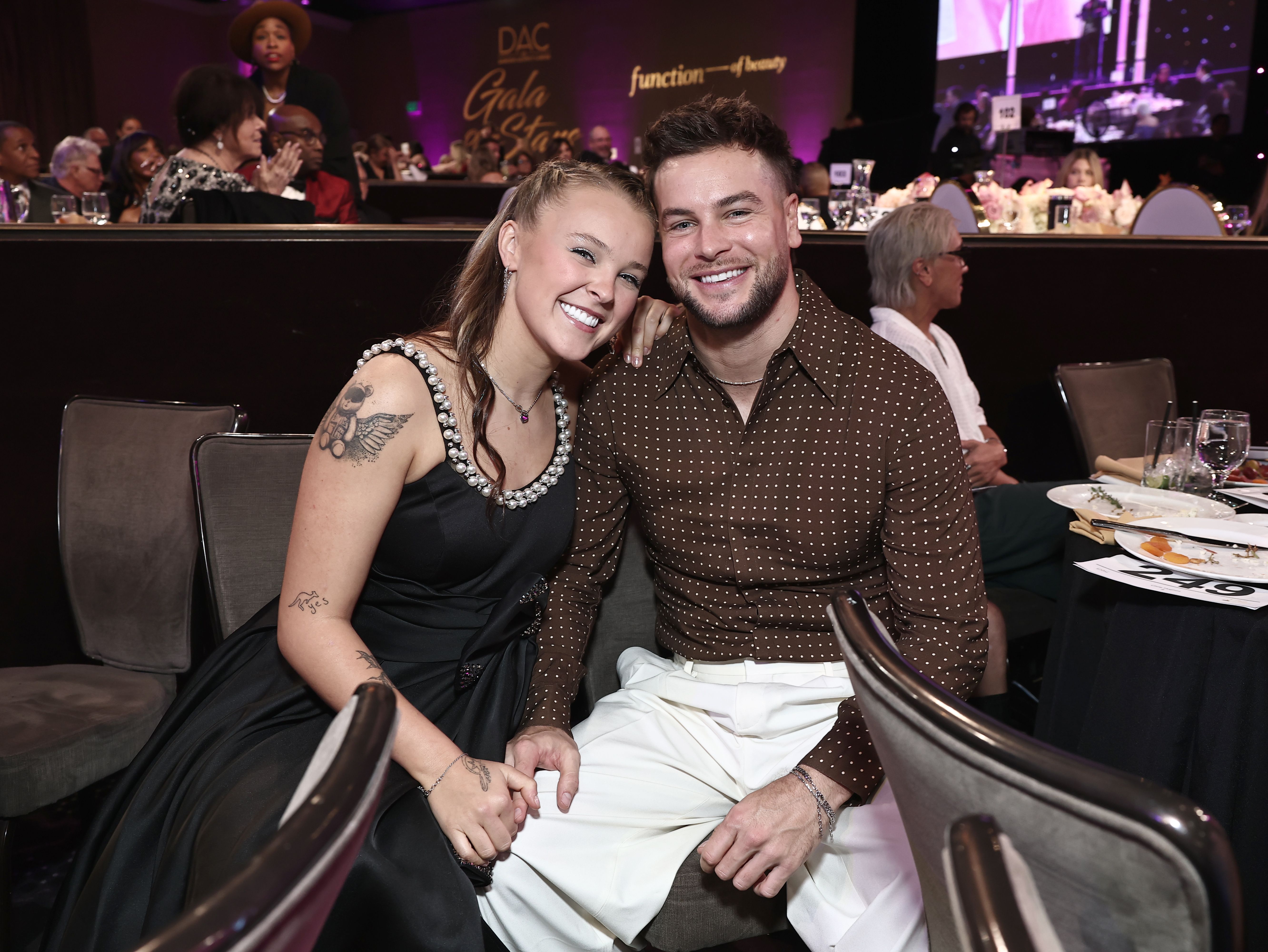 JoJo Siwa and Chris Hughes pose for a photo at the Dancers Against Cancer 2025 Gala of the Stars event.