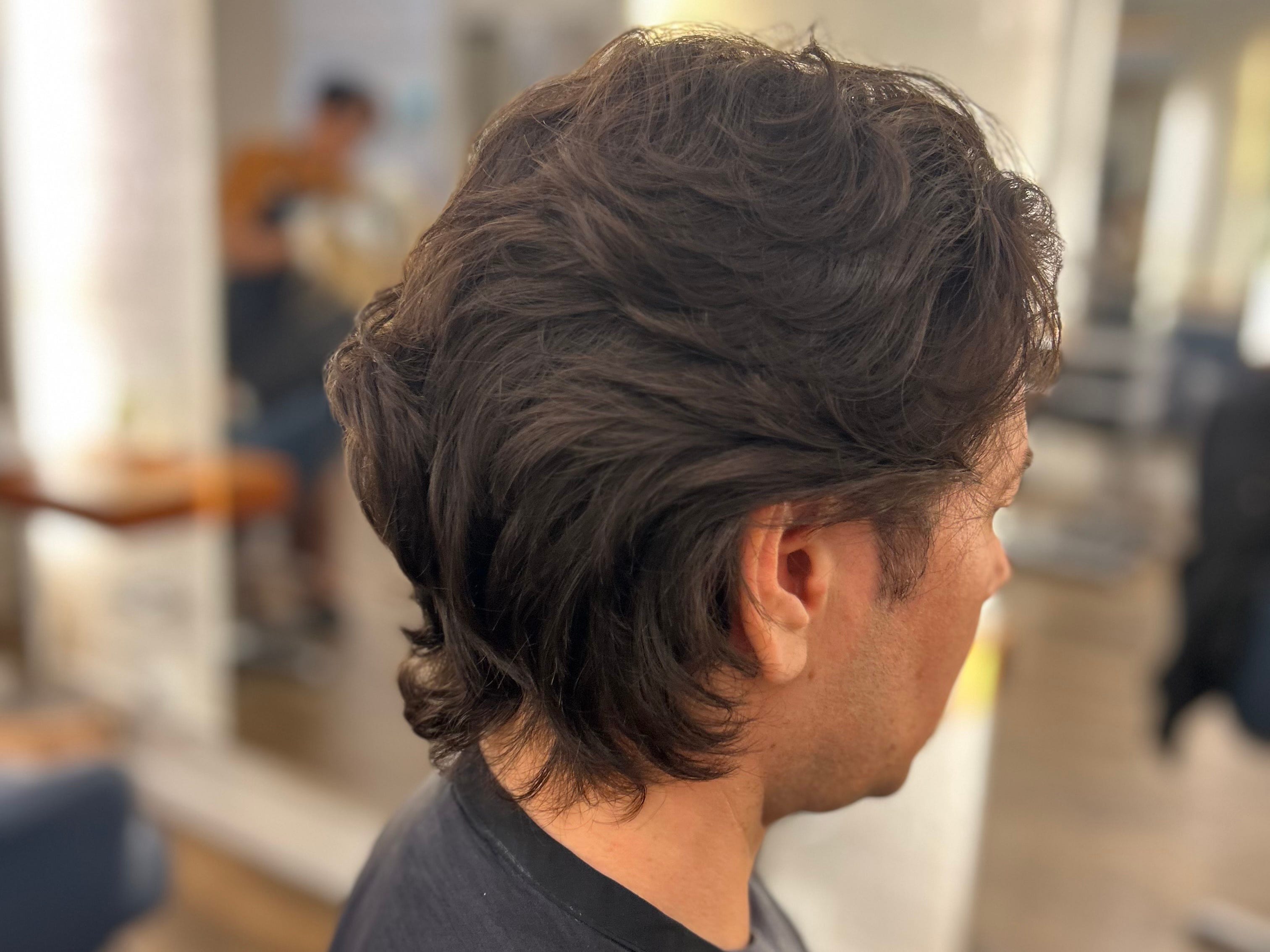 A man wearing a short layered hairstyle.