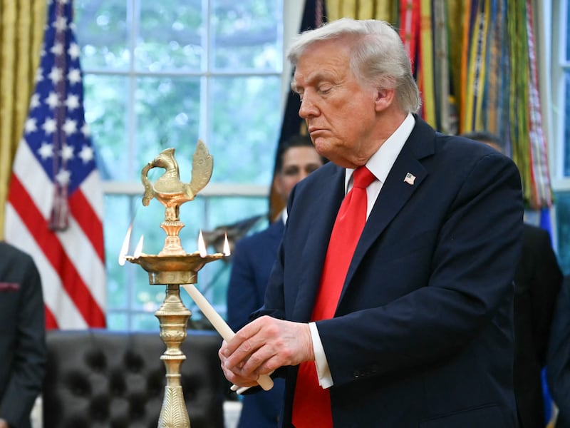 Donald Trump lights a candle during a Diwali celebration