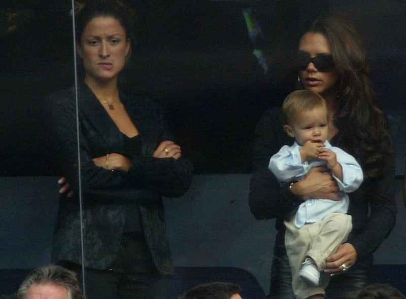MADRID, SPAIN - SEPTEMBER 13: (FILE PHOTO) Victoria Beckham holds son Romeo beside David Beckham's PA Rebecca Loos during the Spanish Primera Liga match between Real Madrid and Valladolid at the Santiago Bernabeu Stadium on September 13, 2003 in Madrid, Spain. David Beckham and former PA Rebecca Loos are under scrutiny for an alleged affair, reported by the News Of The World this weekend. (Photo by Shaun Botterill/Getty Images)