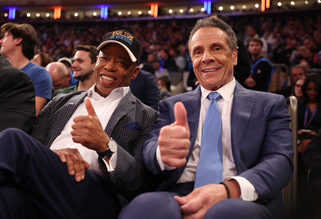New York Mayor Eric Adams and former New York Governor Andrew Cuomo giving thumbs up at a basketball game.