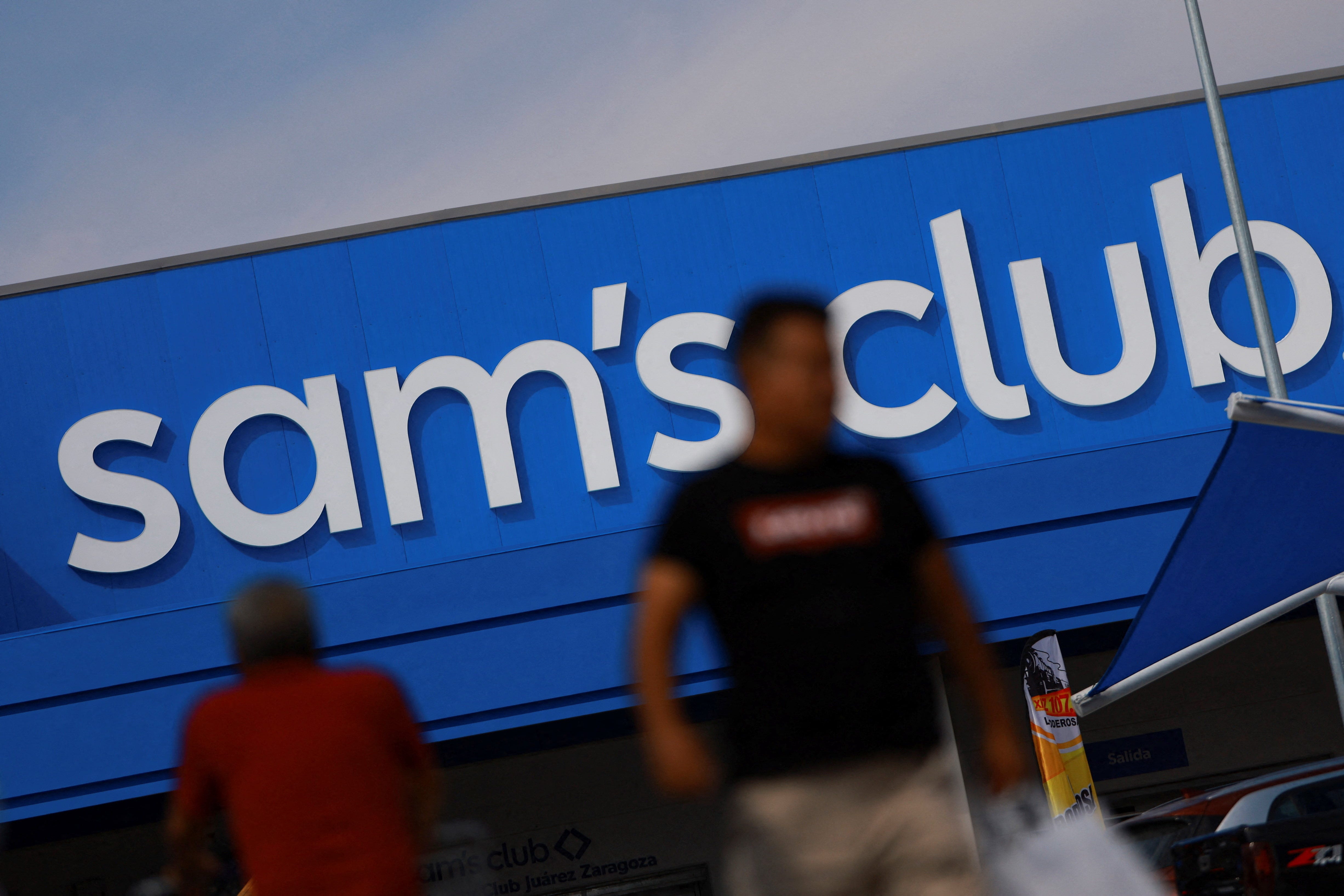People walk past a Sam's Club store in Ciudad Juarez, Mexico.