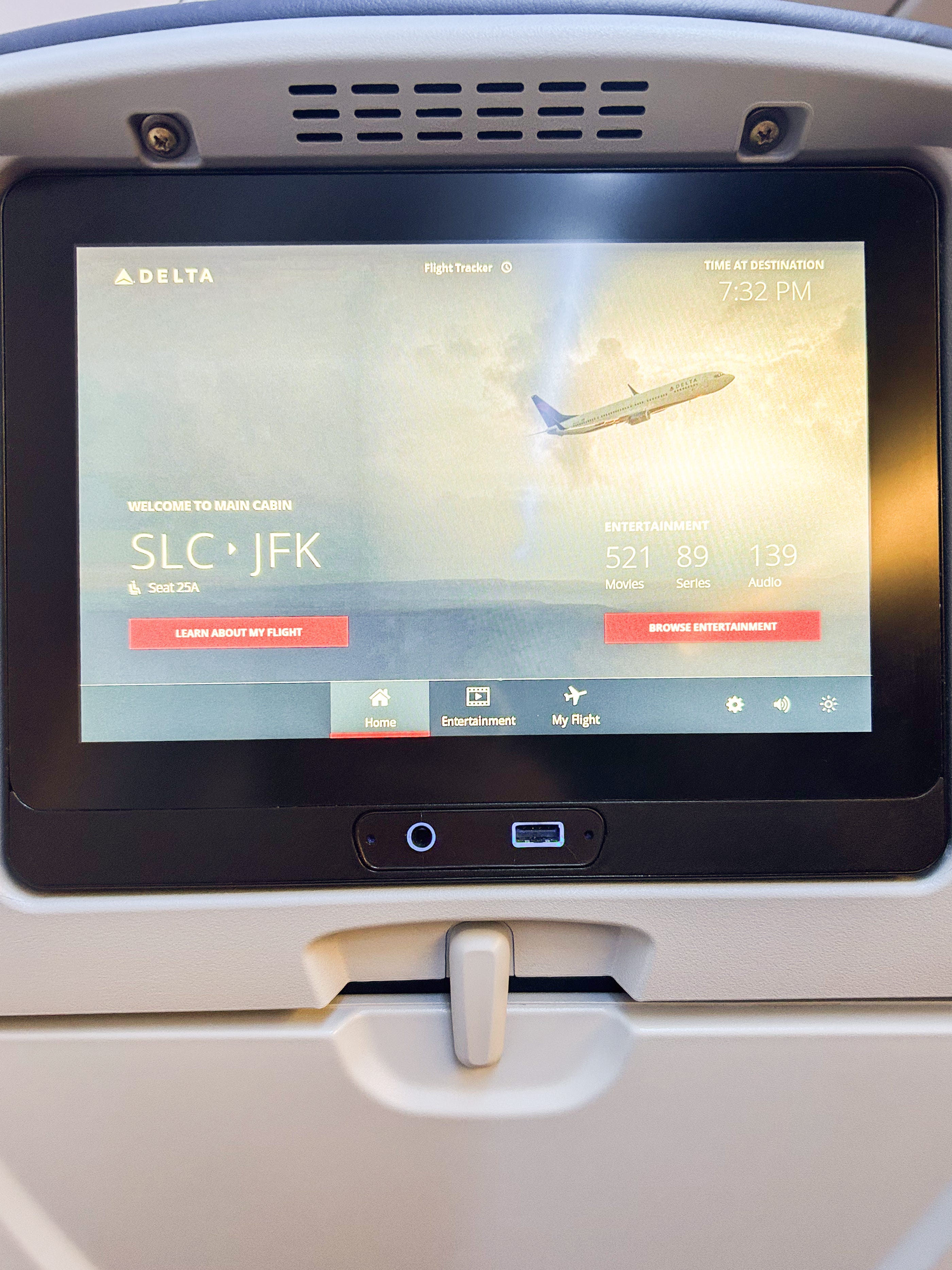 A seatback entertainment screen on a basic economy Delta flight
