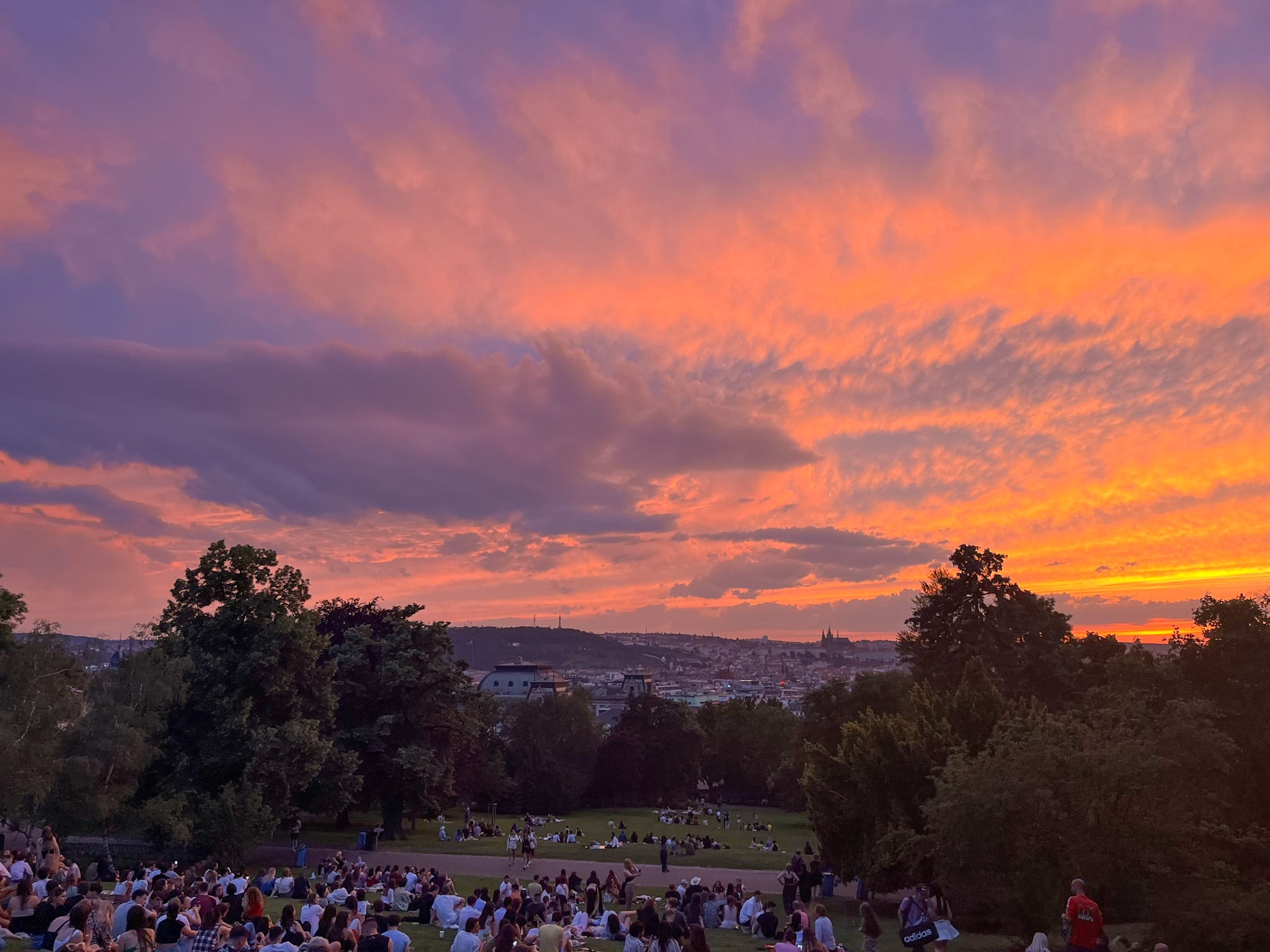 A wide shot of a vibrant sunset at Riegrovy Sady in Prague.