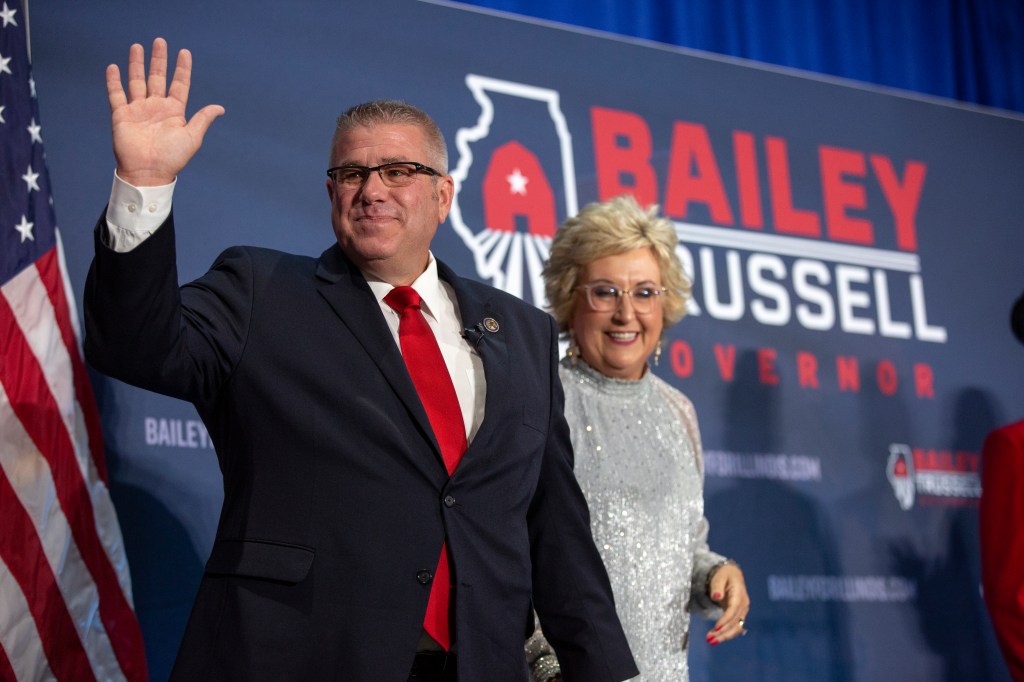Republican gubernatorial candidate Darren Bailey and his wife Cindy Stortzum on stage at an election-night party.