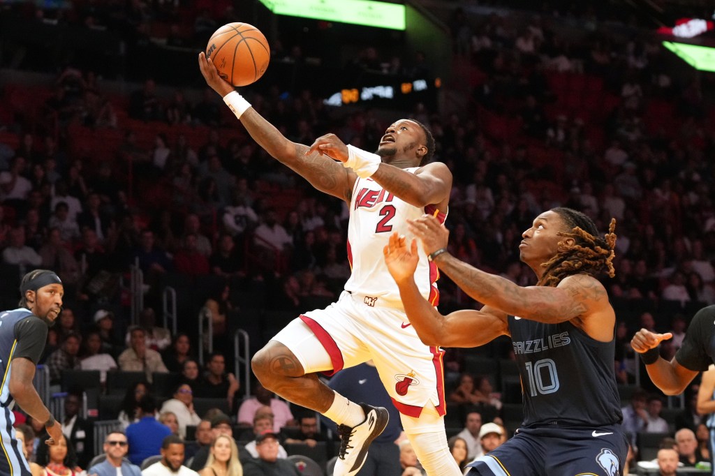 Miami Heat guard Terry Rozier driving to the basket as Memphis Grizzlies guard Javon Small defends.