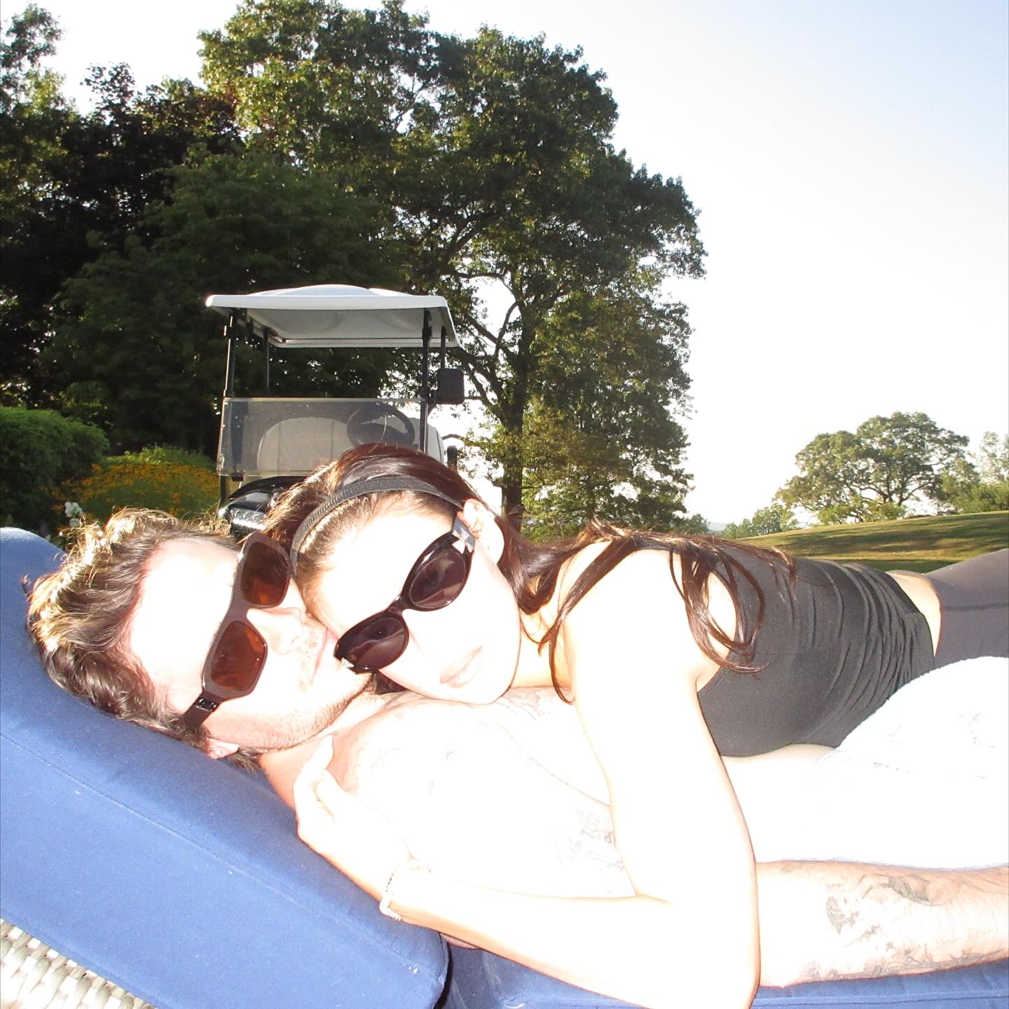 Brooklyn Beckham and Nicola Peltz have a cuddle on a lounge chair.