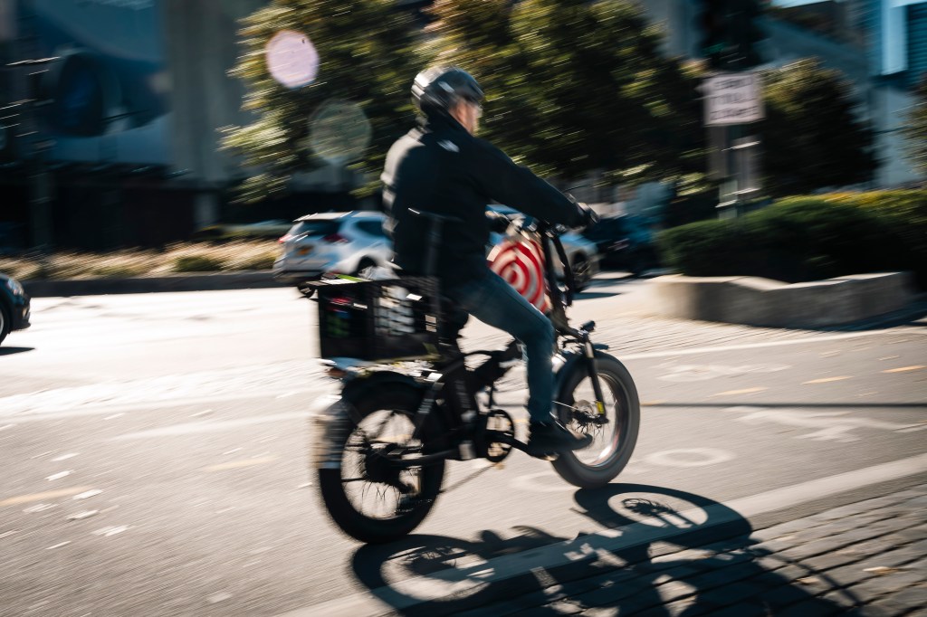 An e-bike rider on the Hudson River Greenway bike path in Manhattan, New York.