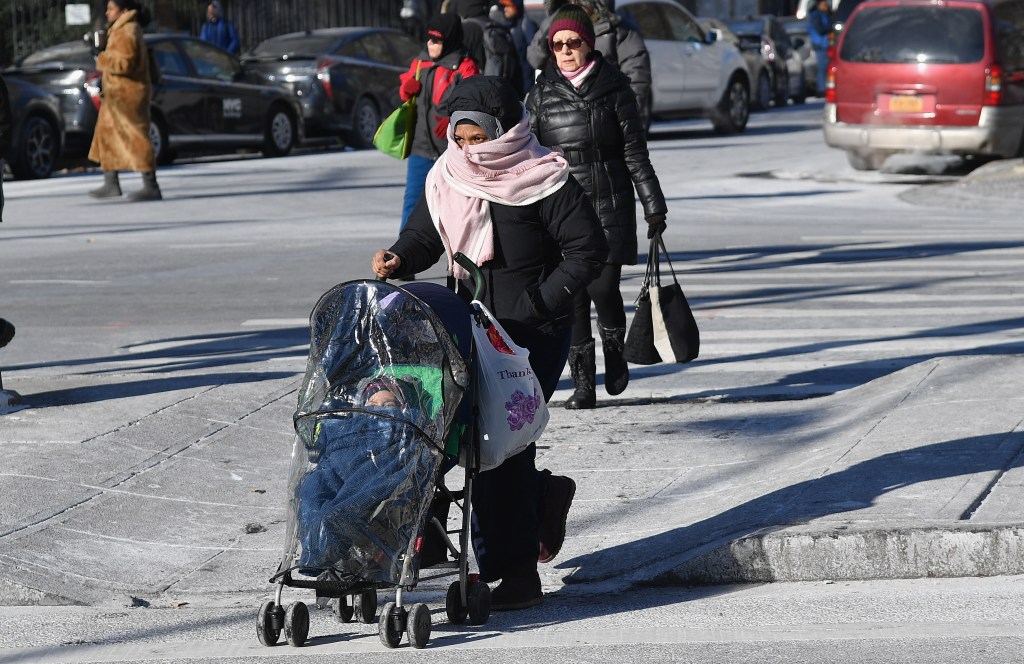 People walking through freezing cold in Brooklyn, New York.