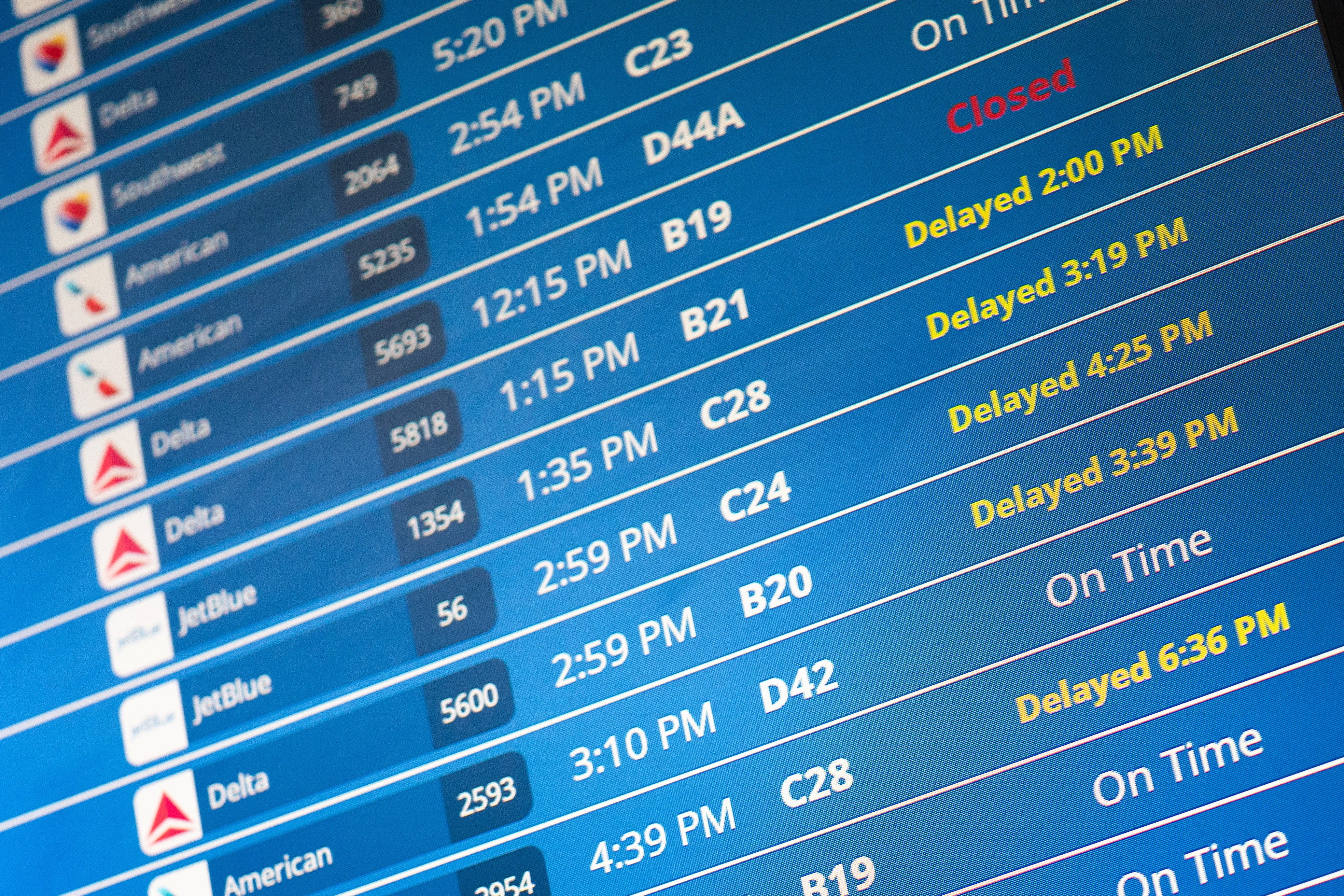Information on delayed flights is displayed at Reagan Washington National Airport as the U.S. government shutdown continues.