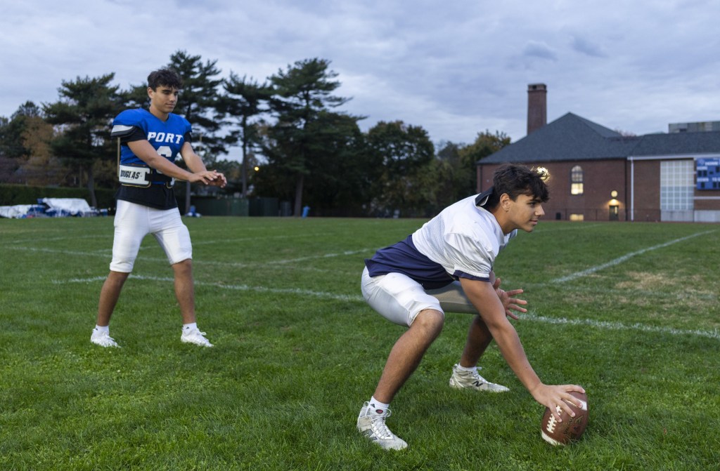 Twins Harry (blue shirt) and Max Eynon of Port Washington High School are juniors and both play lacrosse. Max is one of the top-5 goalkeepers in the nation, recently signing at Ohio State. Harry is the quarterback of the football team and Max plays center.