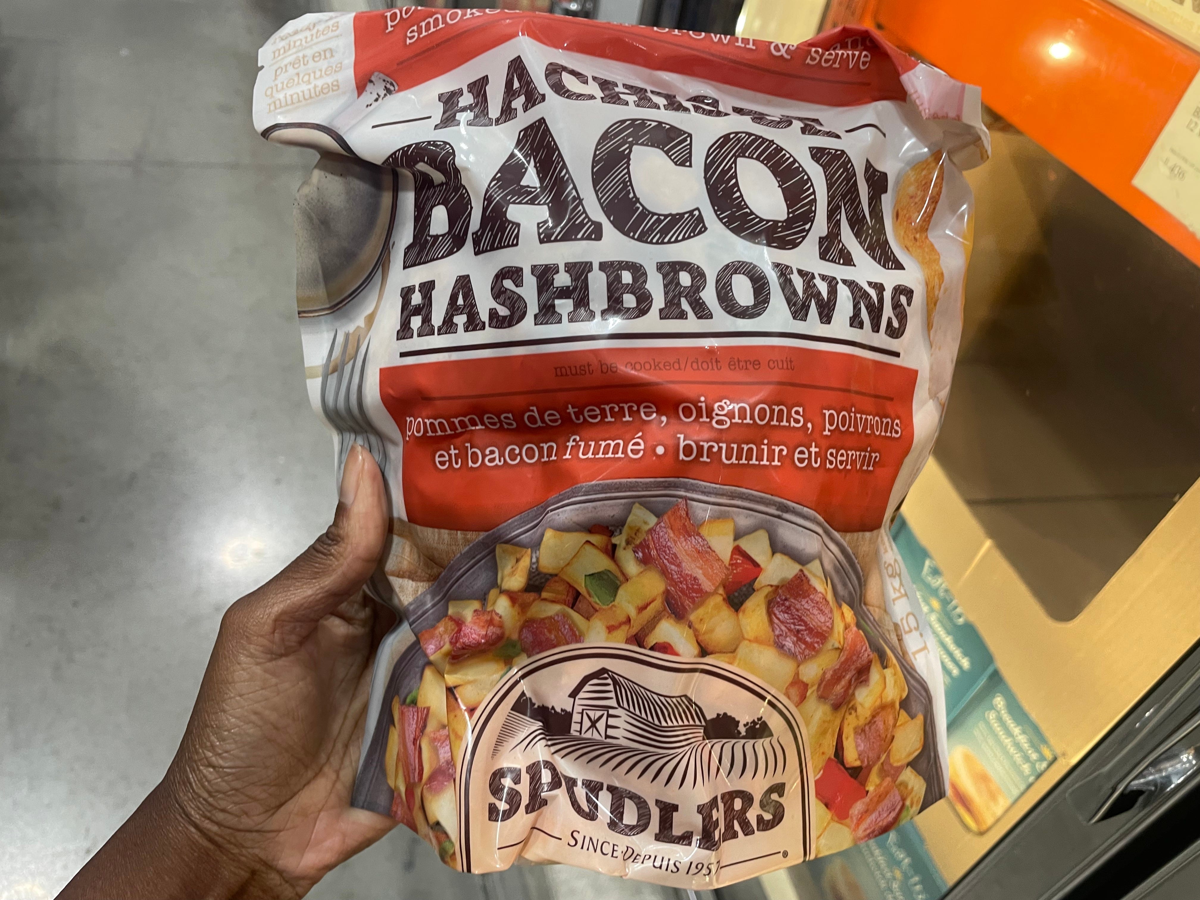 The author holding a bacon of bacon hashbrowns.