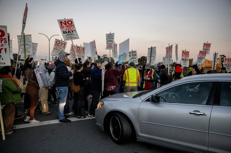 Protesters block a road to Coast Guard Island Alameda during a protest where federal law enforcement agents