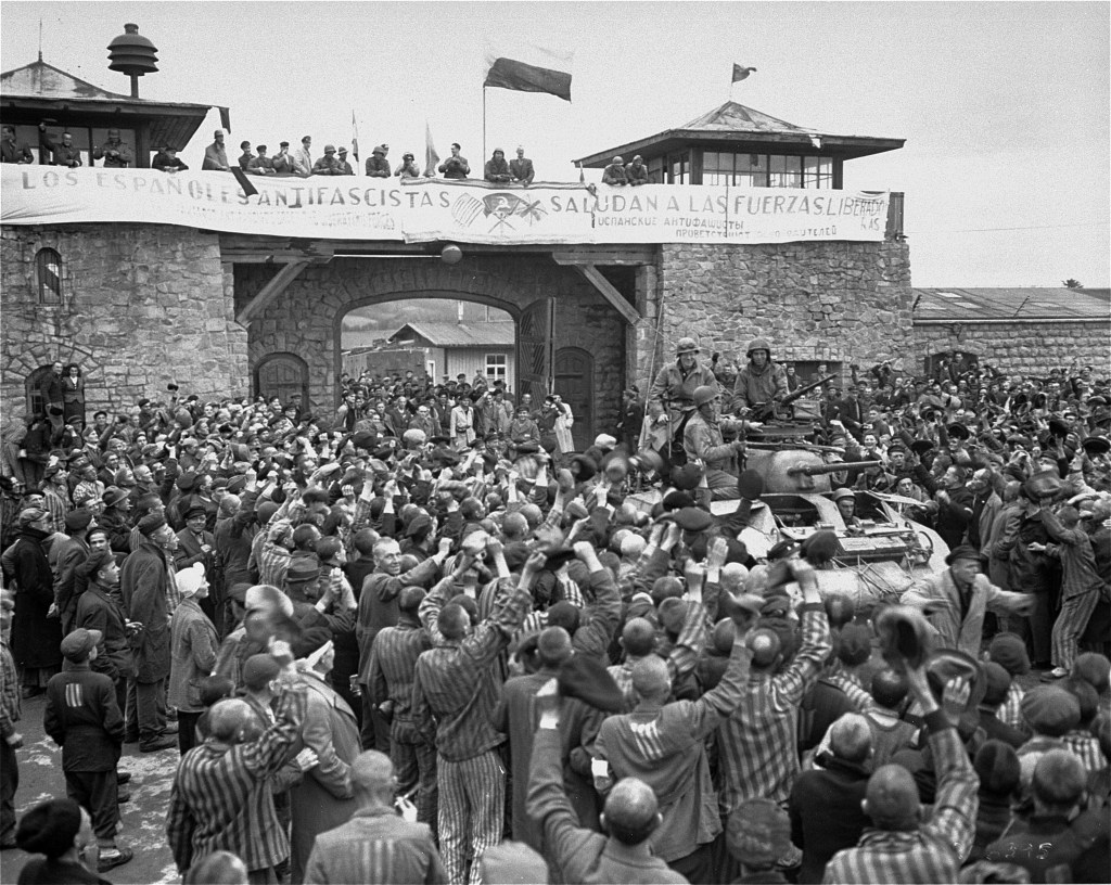 Mauthausen survivors cheering and greeting soldiers of the Eleventh Armored Division of the U.S. Third Army upon their arrival at the concentration camp.