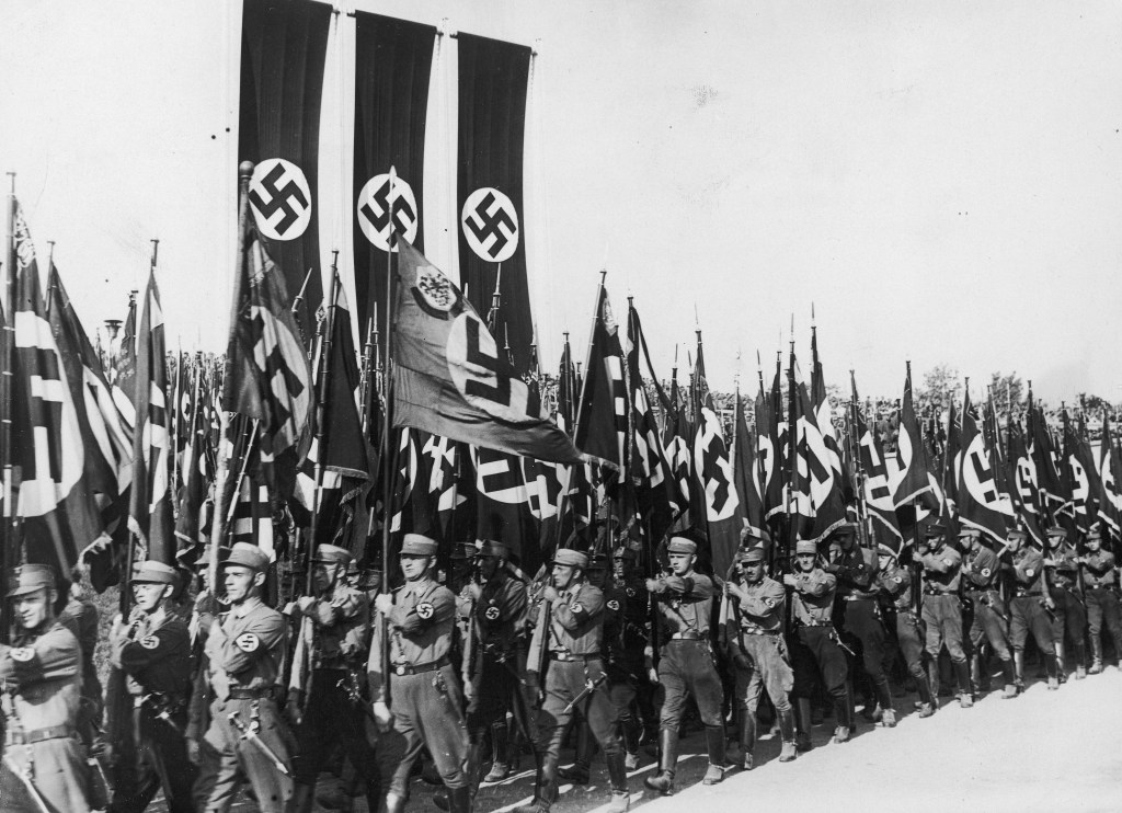 Members of the Nazi Sturmabteilung (SA) marching with swastika banners at the Nuremberg Rally.