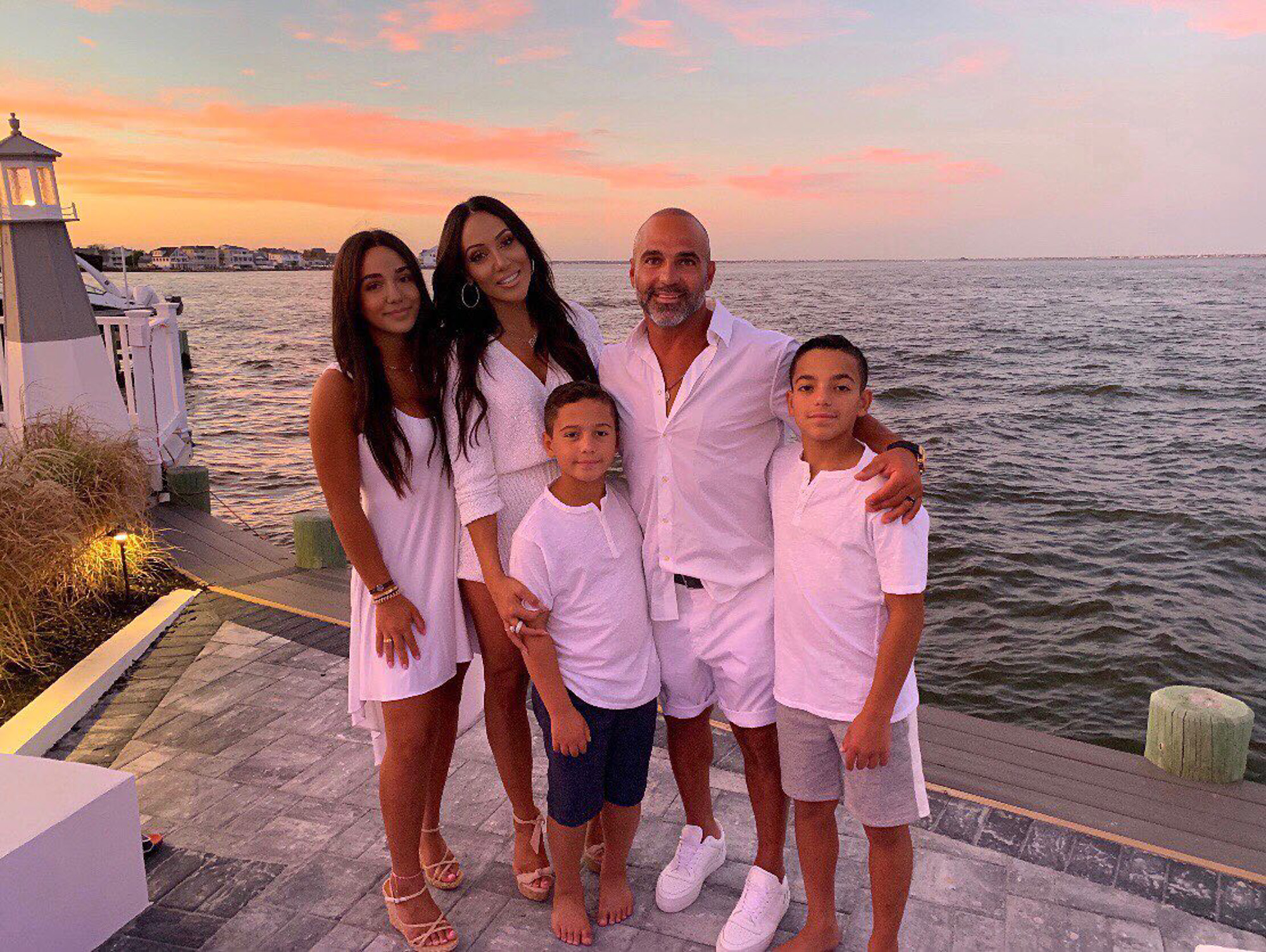 Melissa Gorga and Joe Gorga posing for a photo with their three kids.