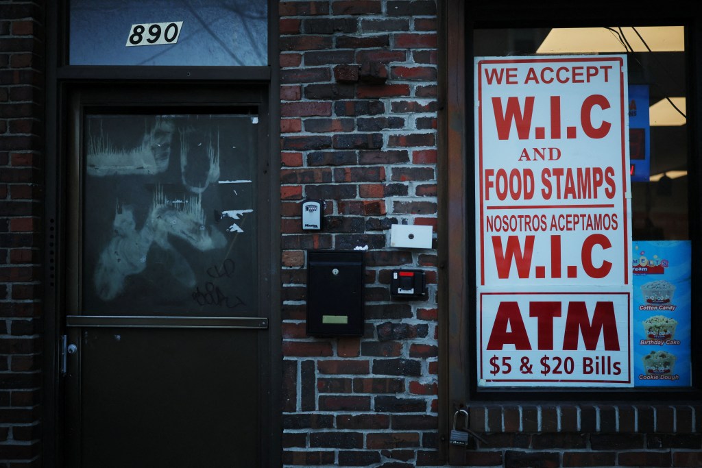 A sign advertises that WIC and Food Stamps are accepted at a convenience store in Chelsea, Mass., as tens of millions of Americans might not receive food stamps and other food aid in November because of the government shutdown.
