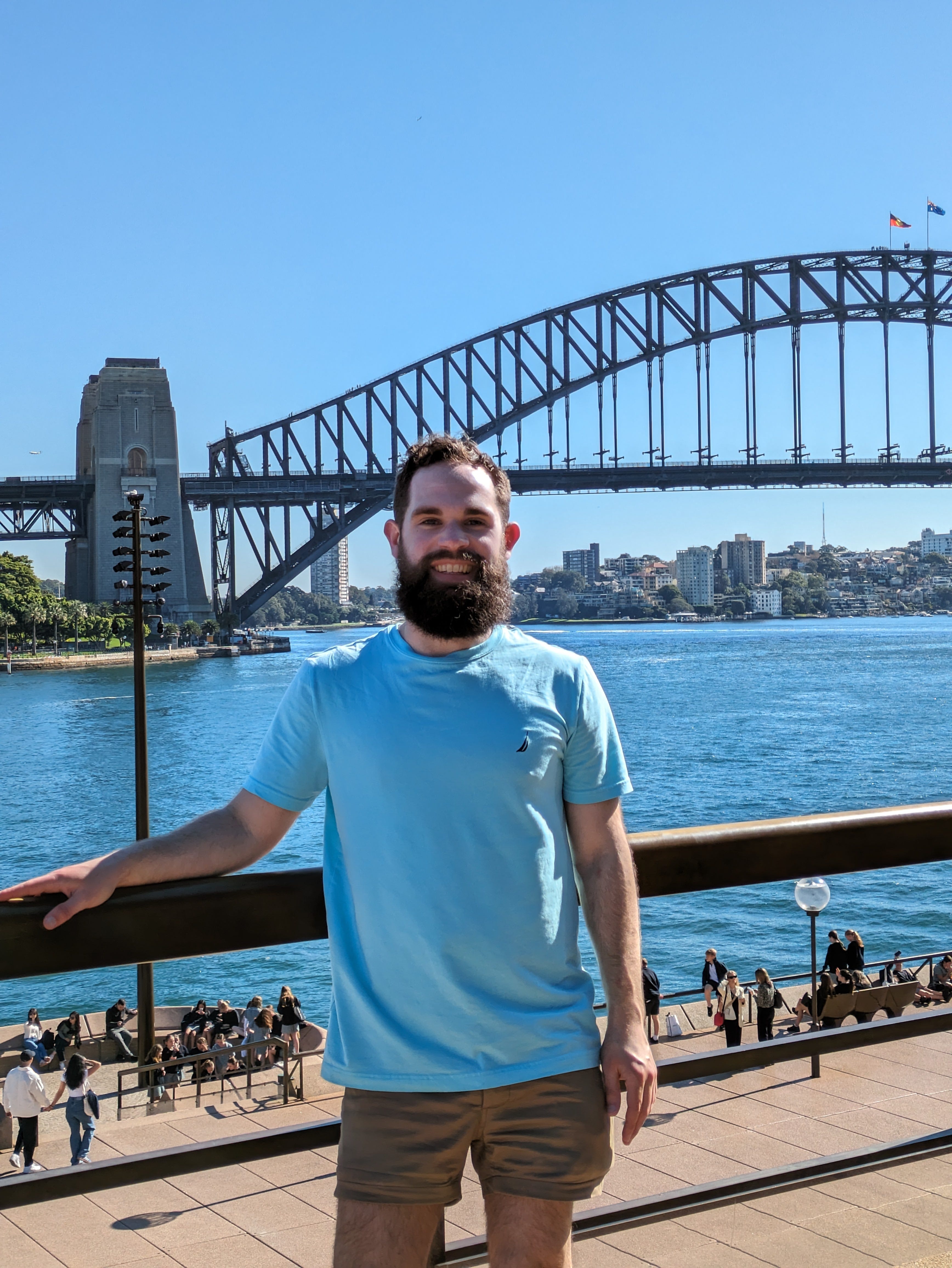 Gabriel Filer standing in front of the Sydney Harbour Bridge
