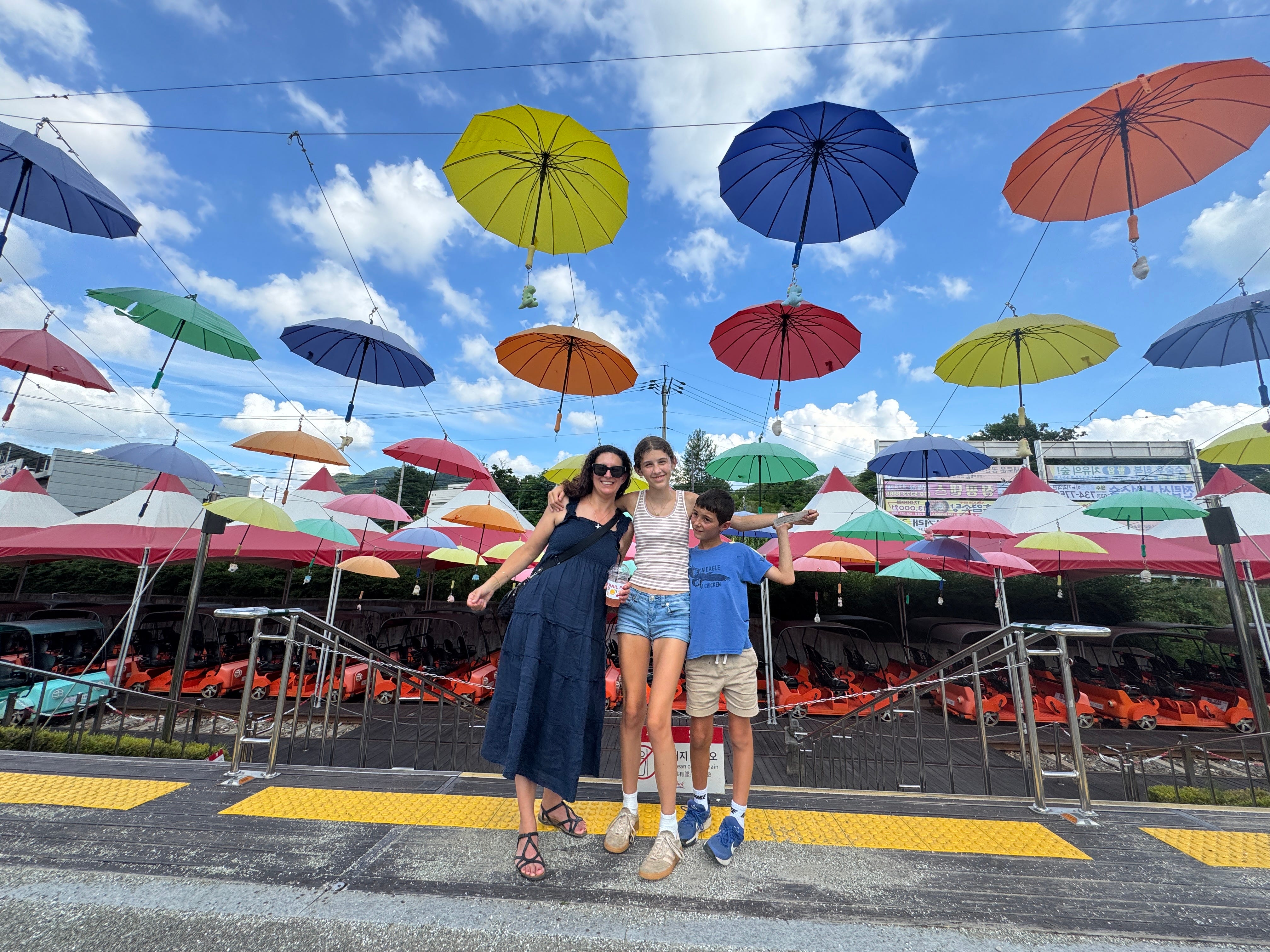 The author with two of her kids under a canopy of umbrellas.