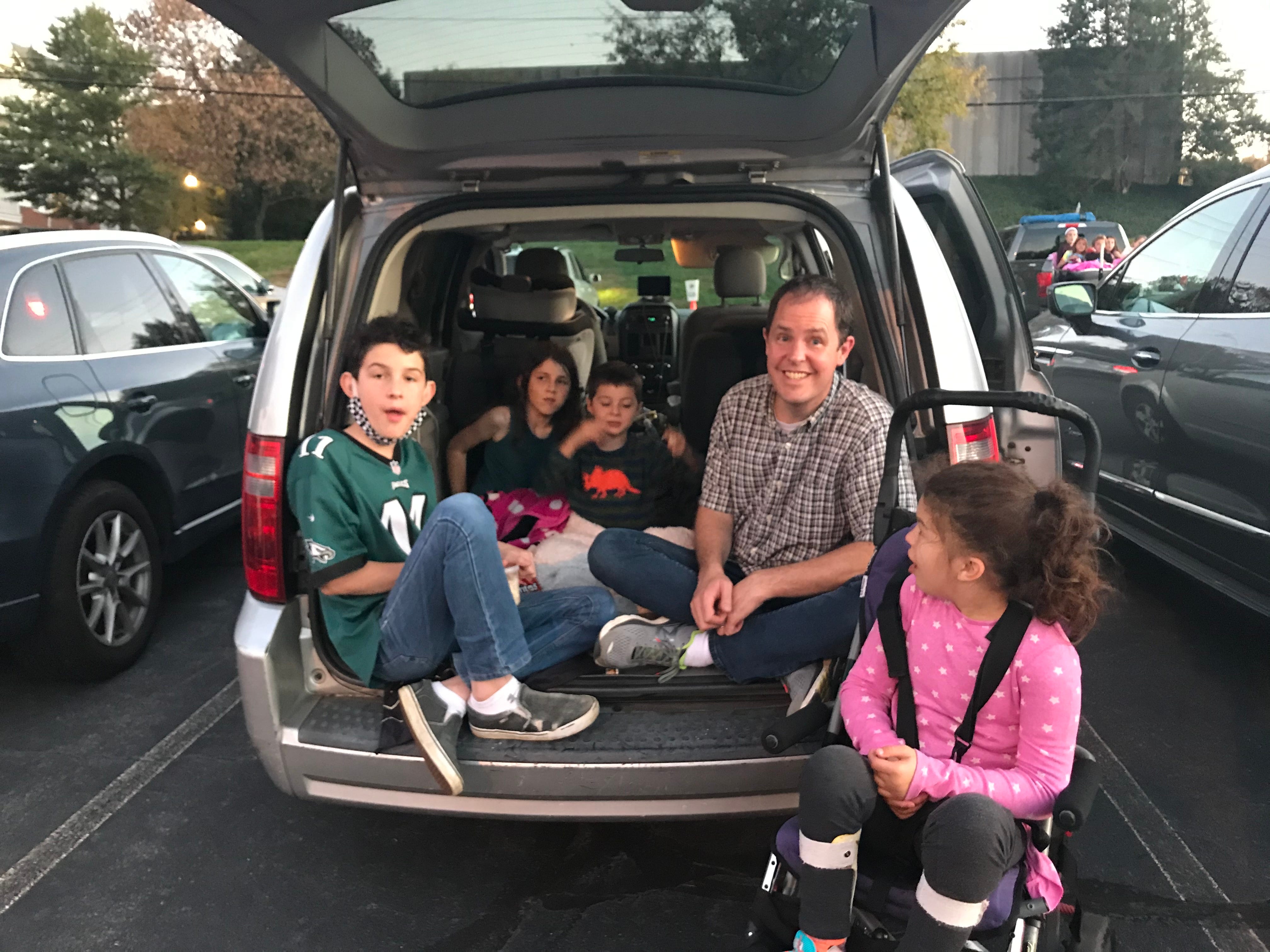 The author's family sitting in the back of a mini van.