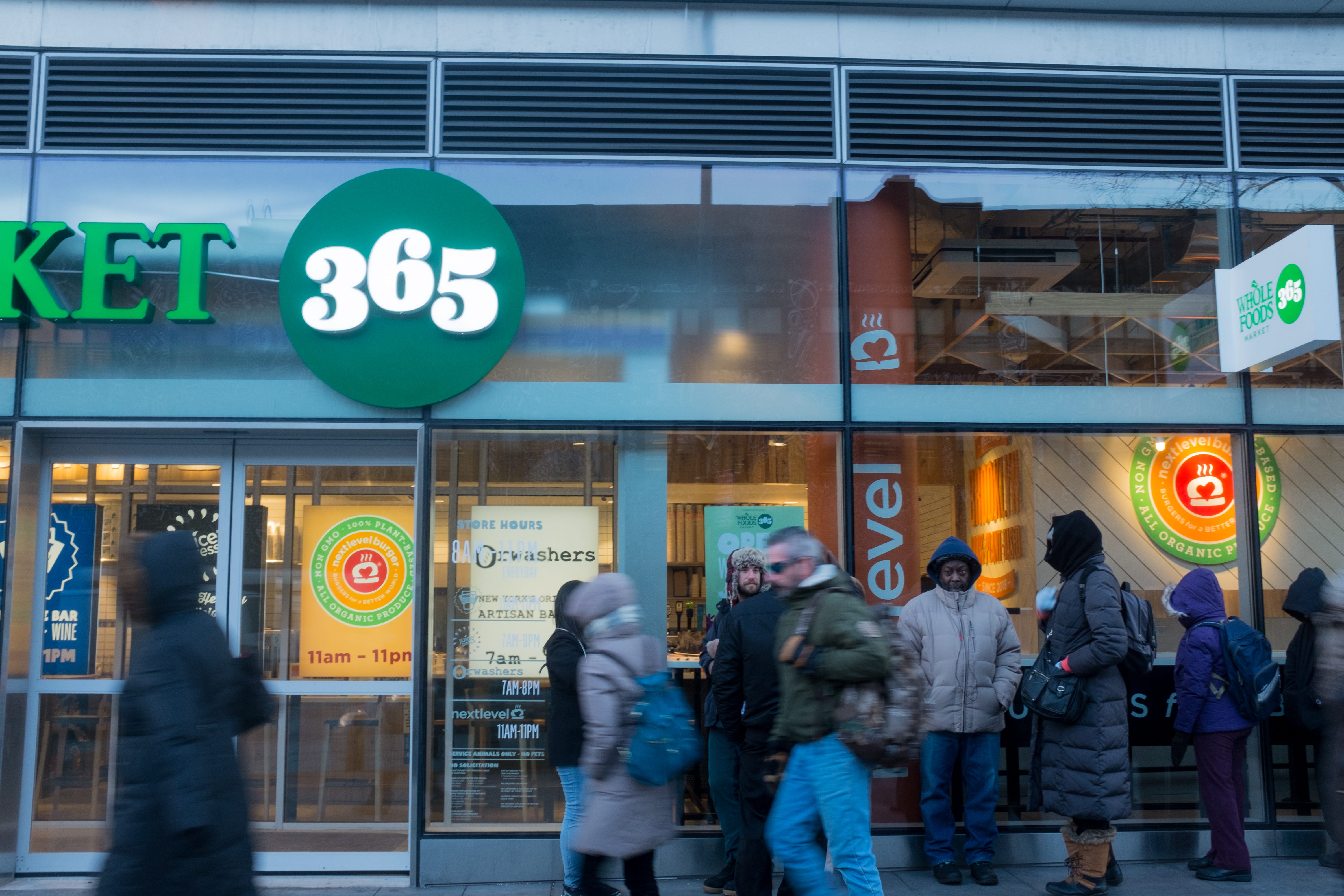 People line up outside of a Whole Foods 365 store