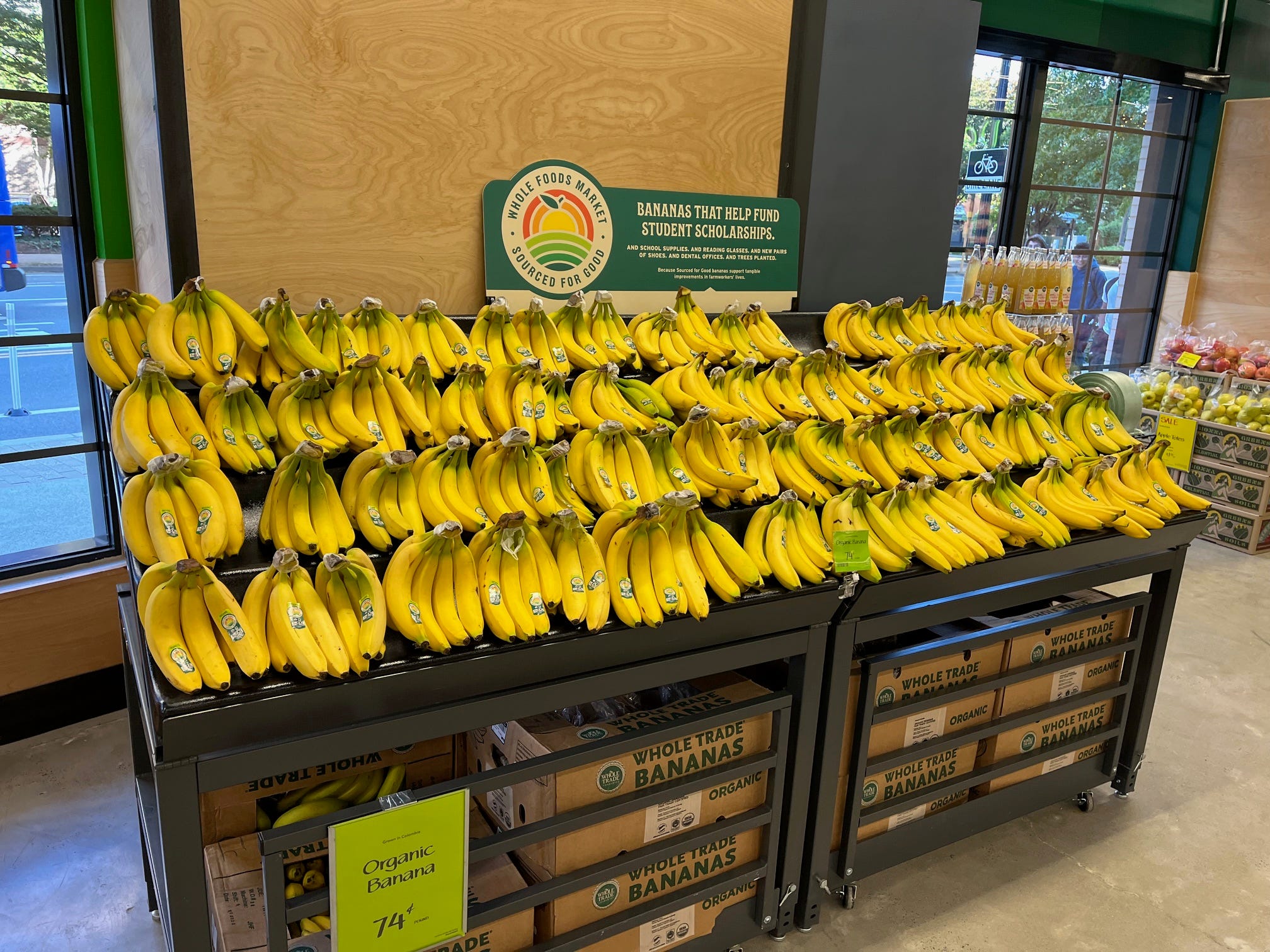 Bananas sit in a display at a Whole Foods Daily Shop store