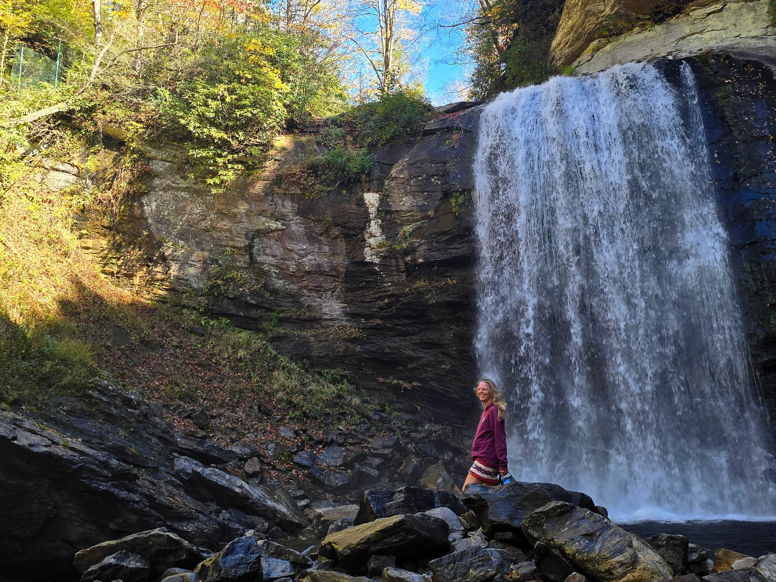 The author smiling for a photo at Looking Glass Falls.
