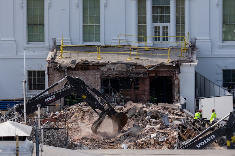 WASHINGTON, DC - OCTOBER 23: An excavator works to clear rubble after the East Wing of the White House was demolished on October 23, 2025 in Washington, DC. The demolition is part of U.S. President Donald Trump's plan to build a ballroom reportedly costing at least $250 million on the eastern side of the White House.