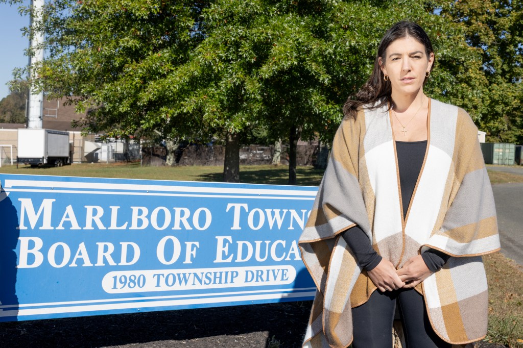 Danielle Bellomo standing in front of a blue Marlboro Board of Education sign.