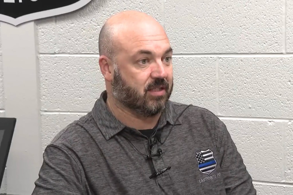 David Scott Jr. wearing a grey polo with an Eastpointe PD shield emblem.