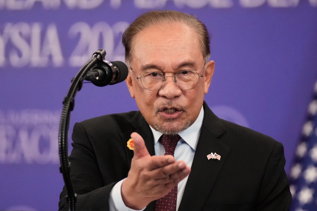 Malaysian Prime Minister Anwar Ibrahim speaks at a podium.