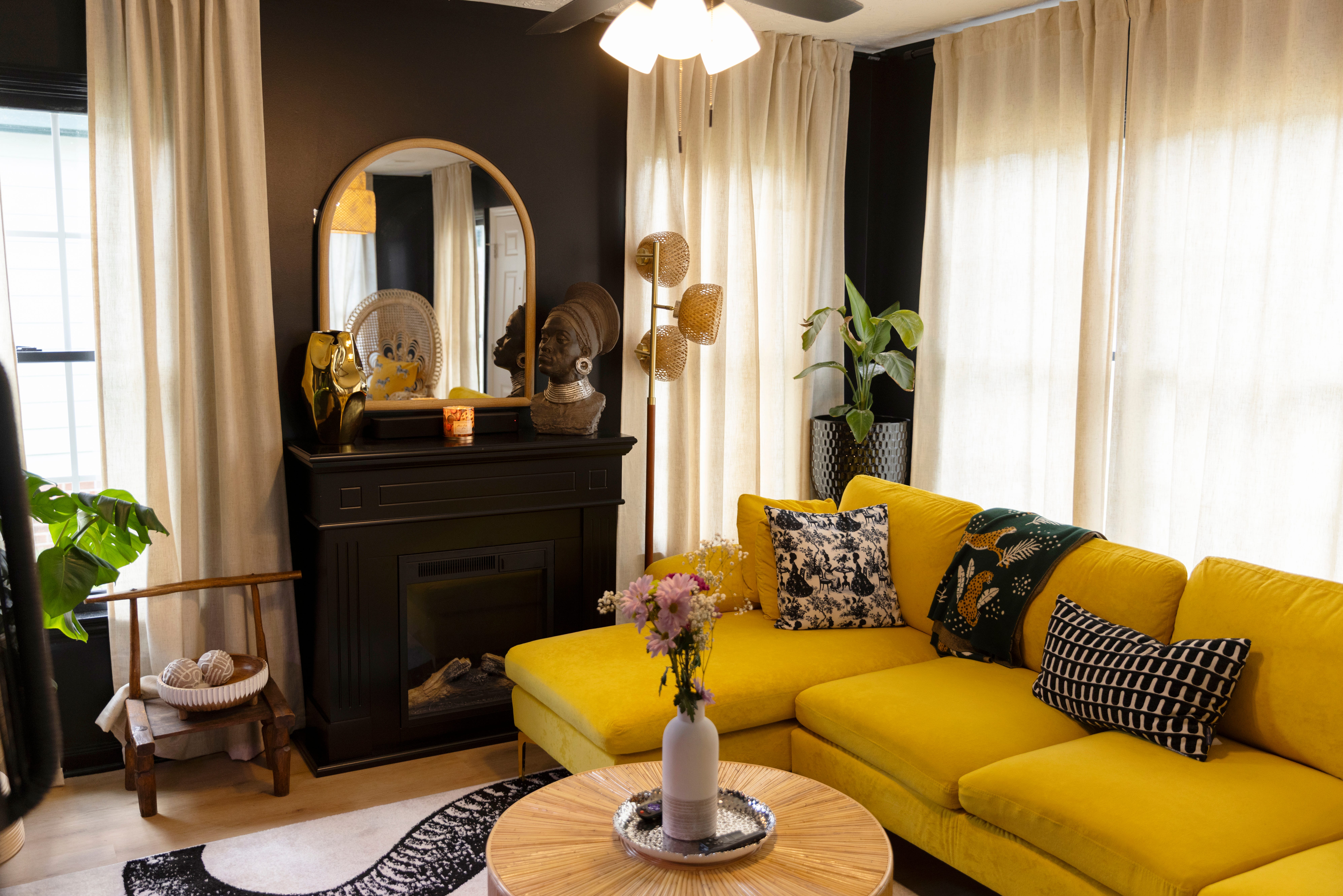 A living room with a yellow couch.