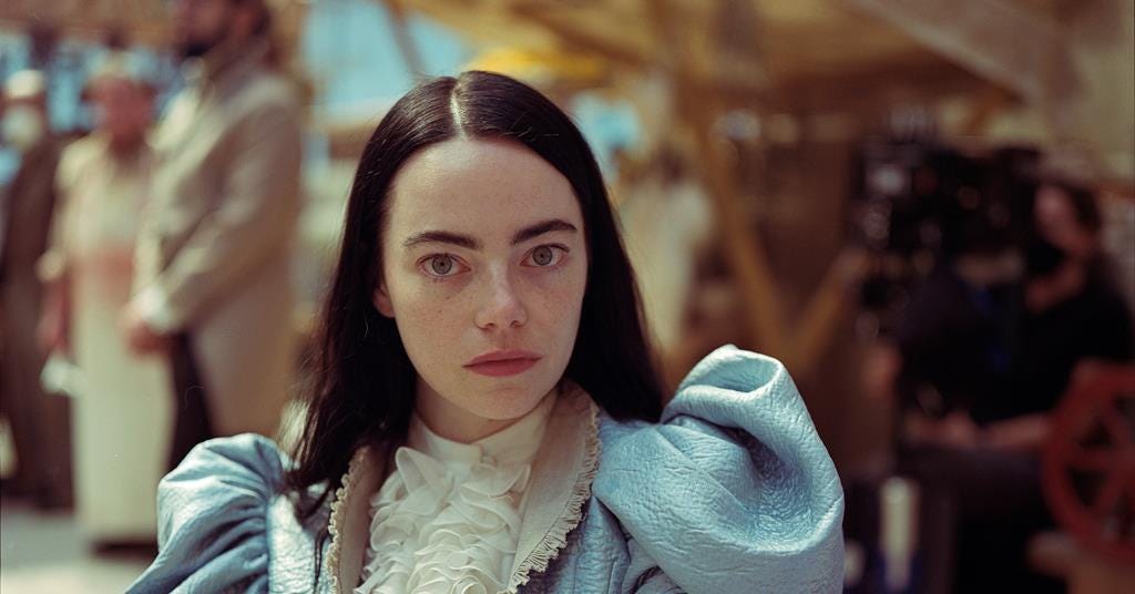 Emma Stone in a puffy dress on a the set of Poor Things