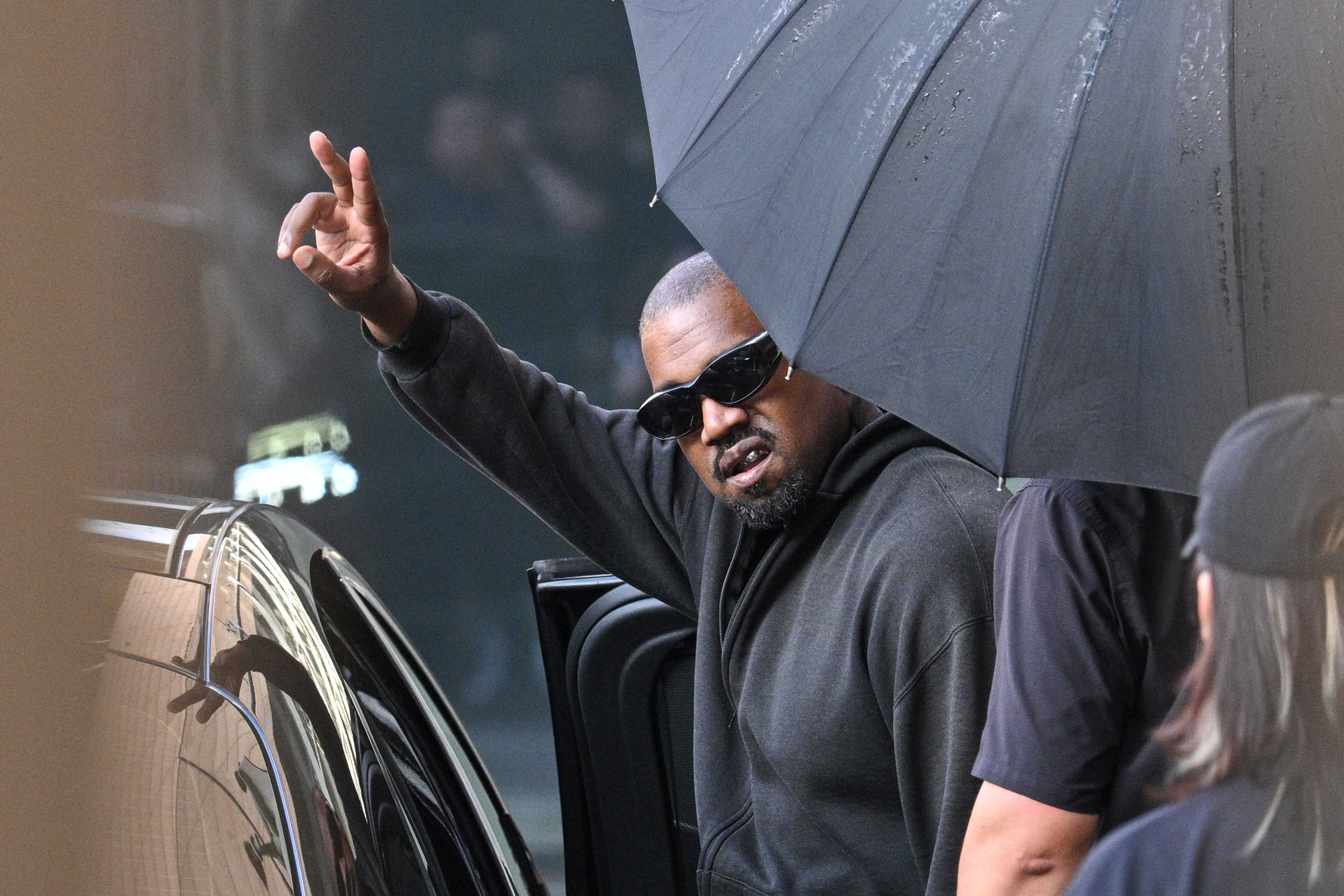 Kanye West giving the peace sign.