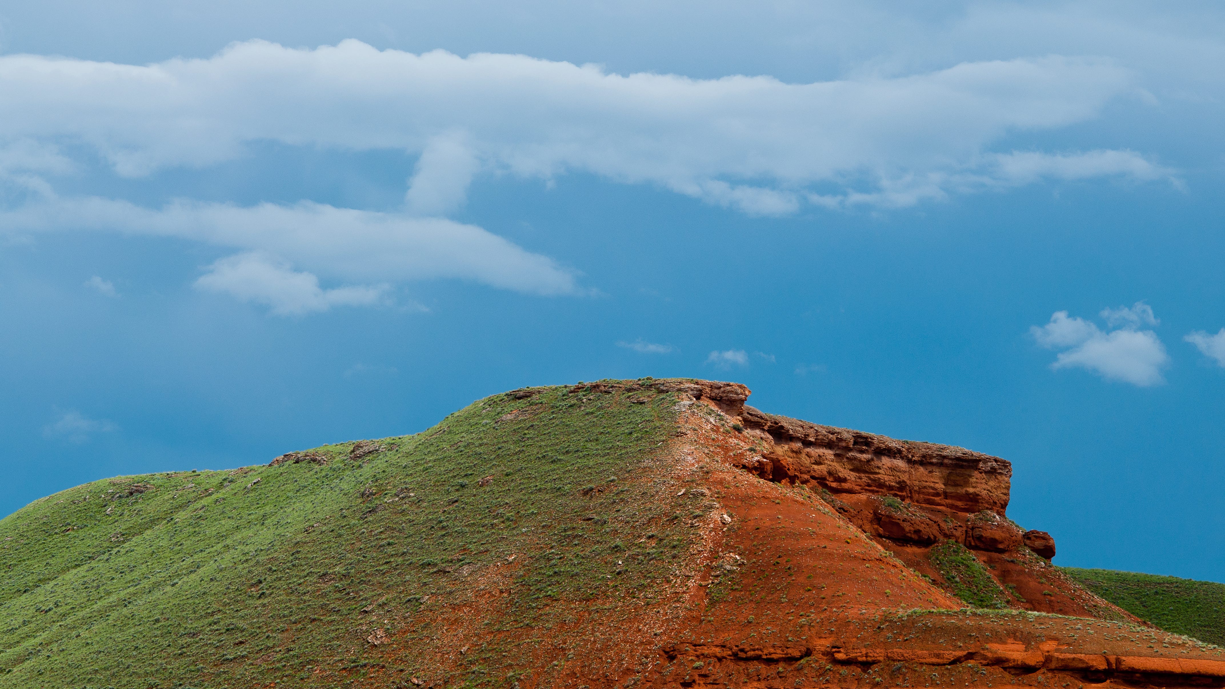 Blue skies over Big Horn Mountain badlands in Greybull, Wyoming.