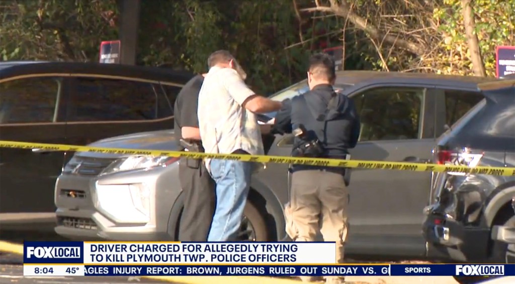 Police officers arresting Dalton Lee Janiczek for attempted murder after he allegedly struck two police officers with his vehicle.