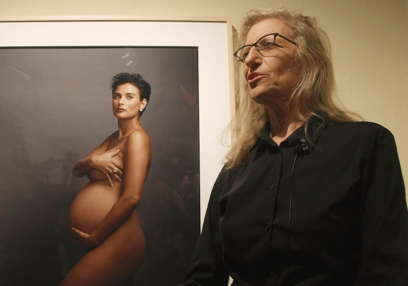 BERLIN - FEBRUARY 20:  Photographer Annie Leibovitz speaks to the media while standing in front of a portrait of pregnant actress Demi Moore during a walk-through of the exhibition
