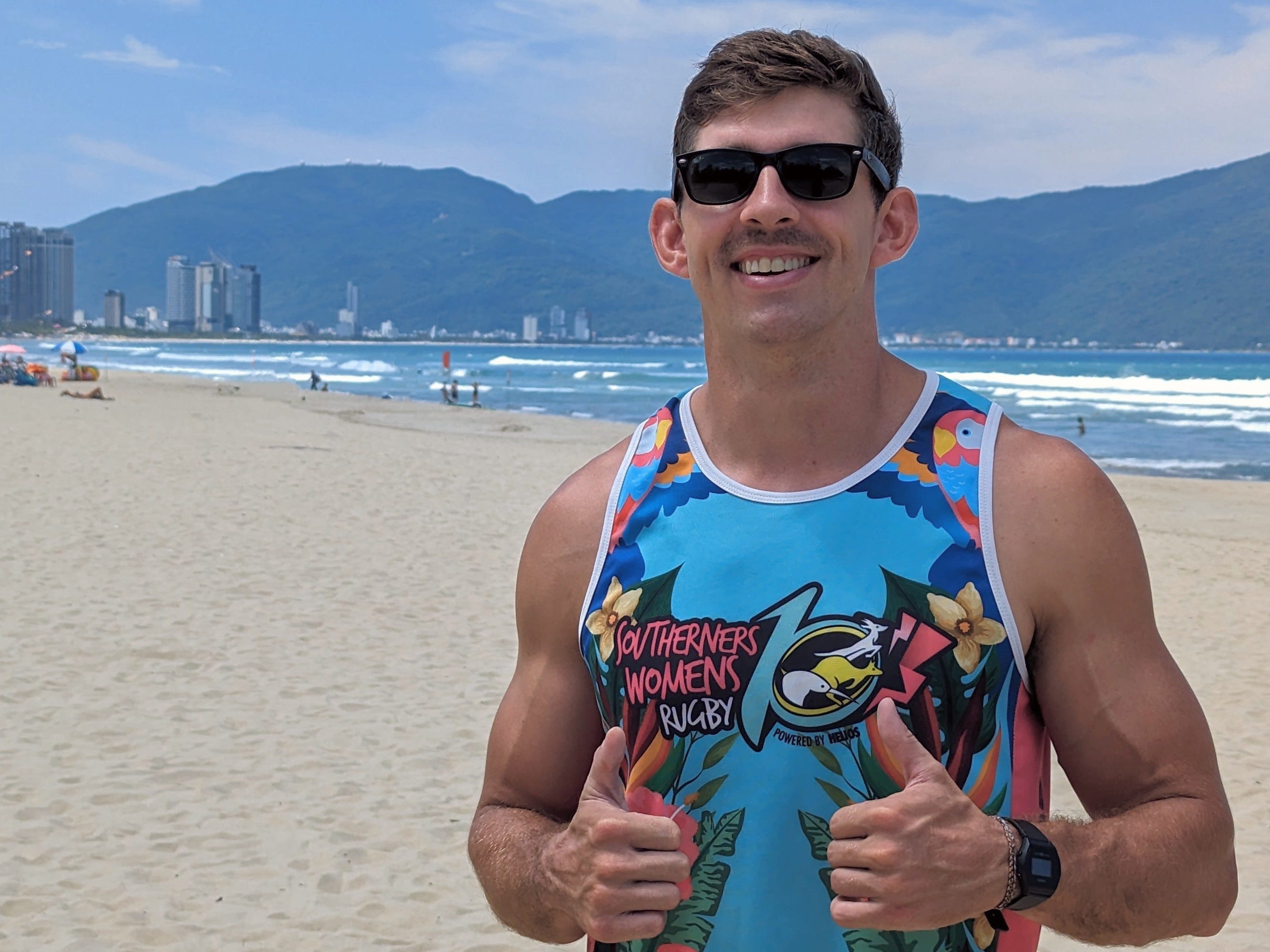 A man posing on the beach.