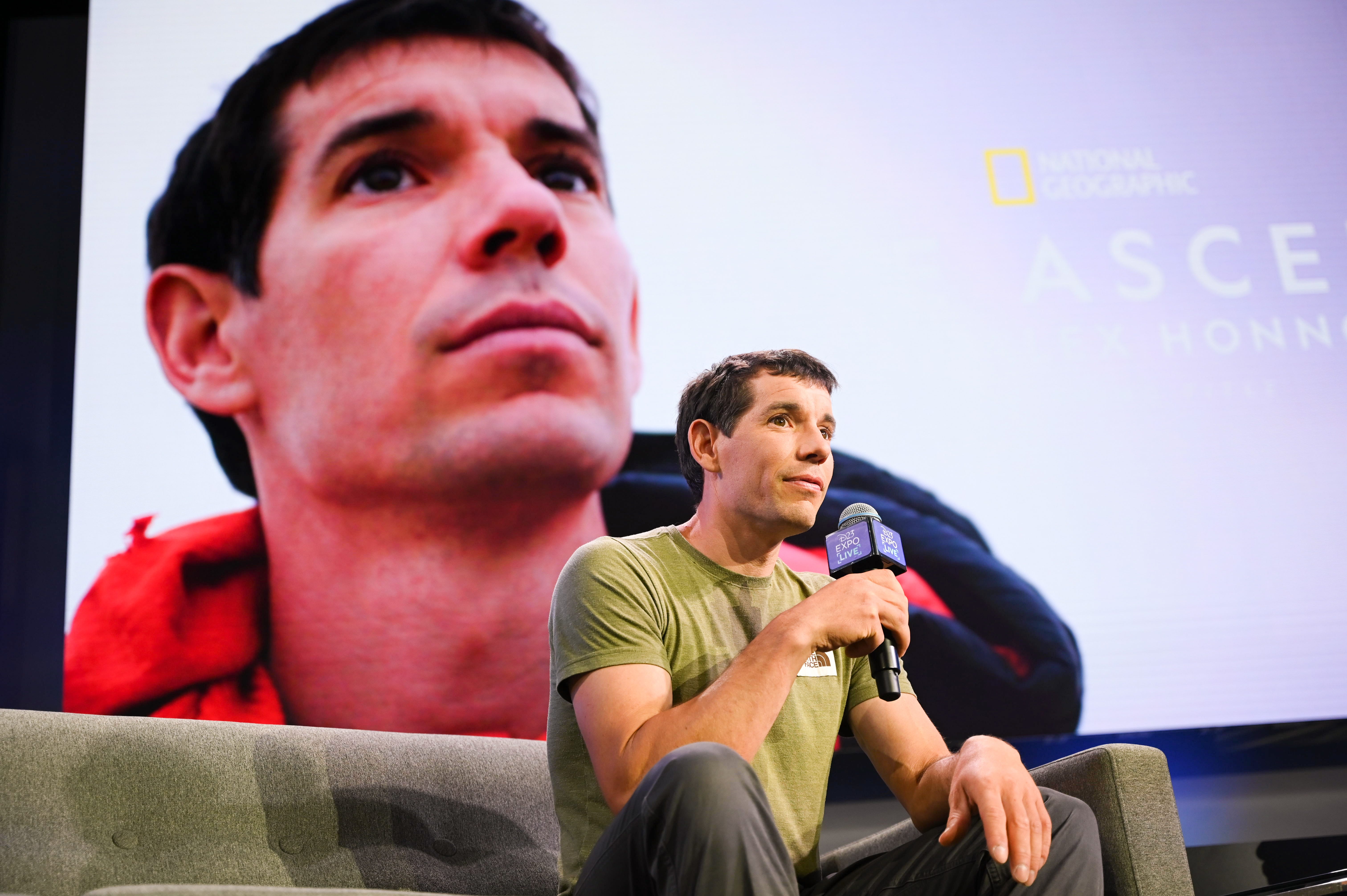 Alex Honnold on stage with mic.