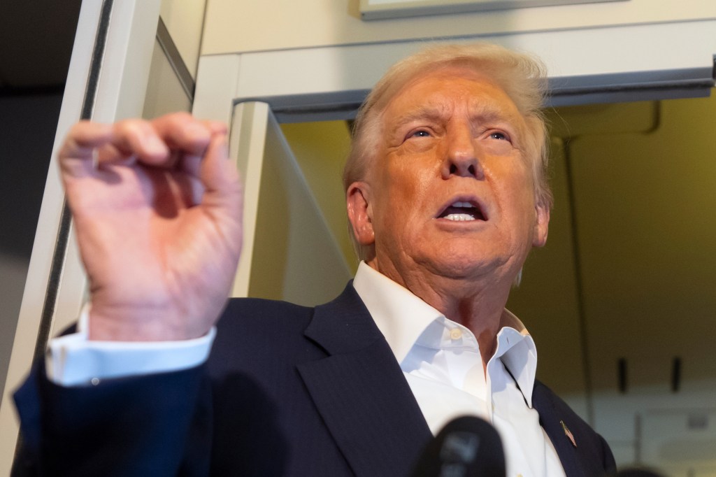 Donald Trump speaking to reporters on Air Force One.