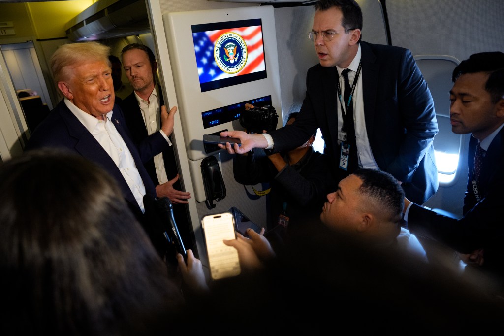 Donald Trump speaks to reporters aboard Air Force One with U.S. Trade Representative Jamieson Greer.