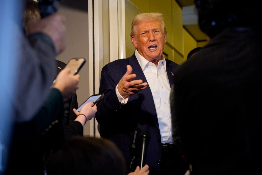 U.S. President Donald Trump speaks to the media aboard Air Force One.