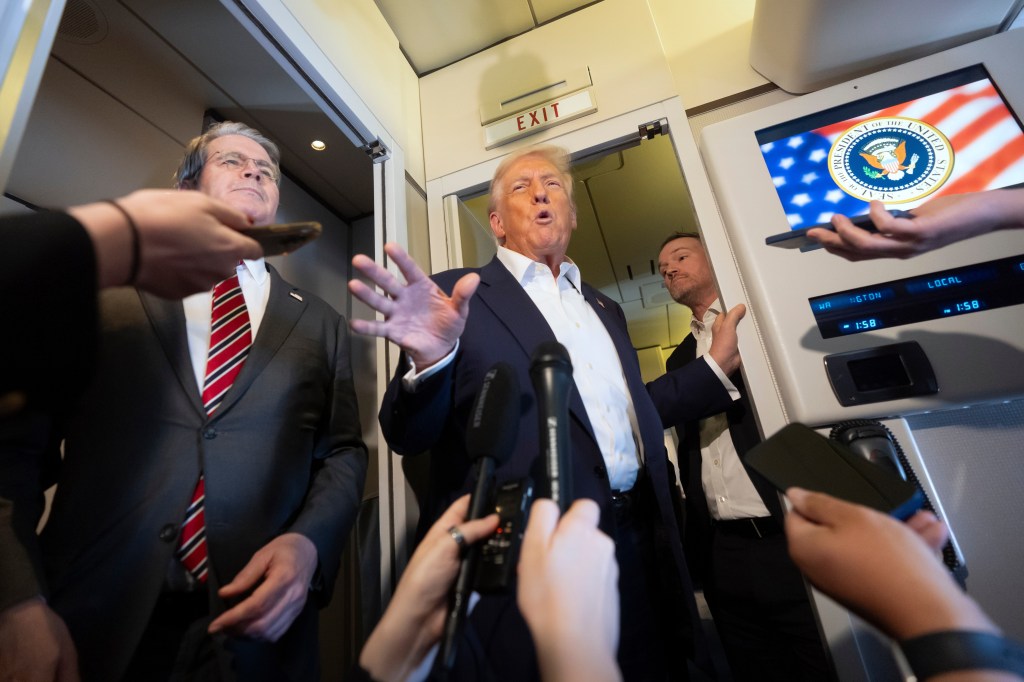 Donald Trump speaks to reporters aboard Air Force One, flanked by Scott Bessent and Jamieson Greer.